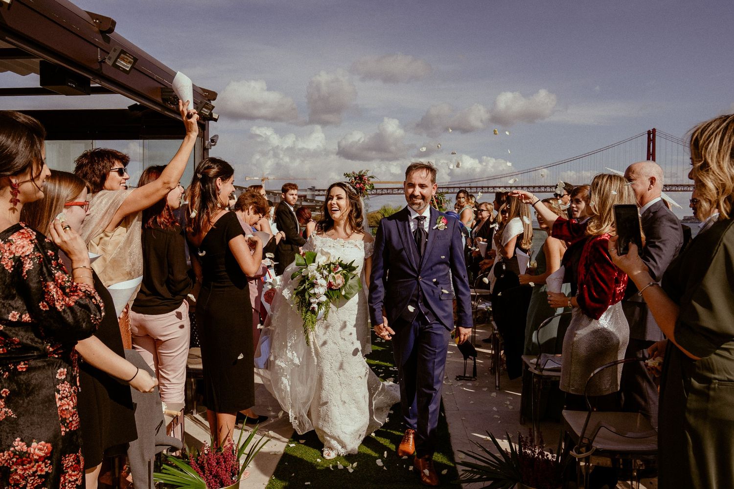 Wedding guests celebrate with sparklers outside during sunset, creating a joyful outdoor party atmosphere.