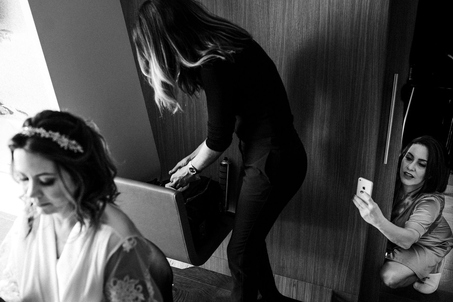 Black and white photo collage of intimate wedding moments during preparation and portraits with elegant details and lighting.