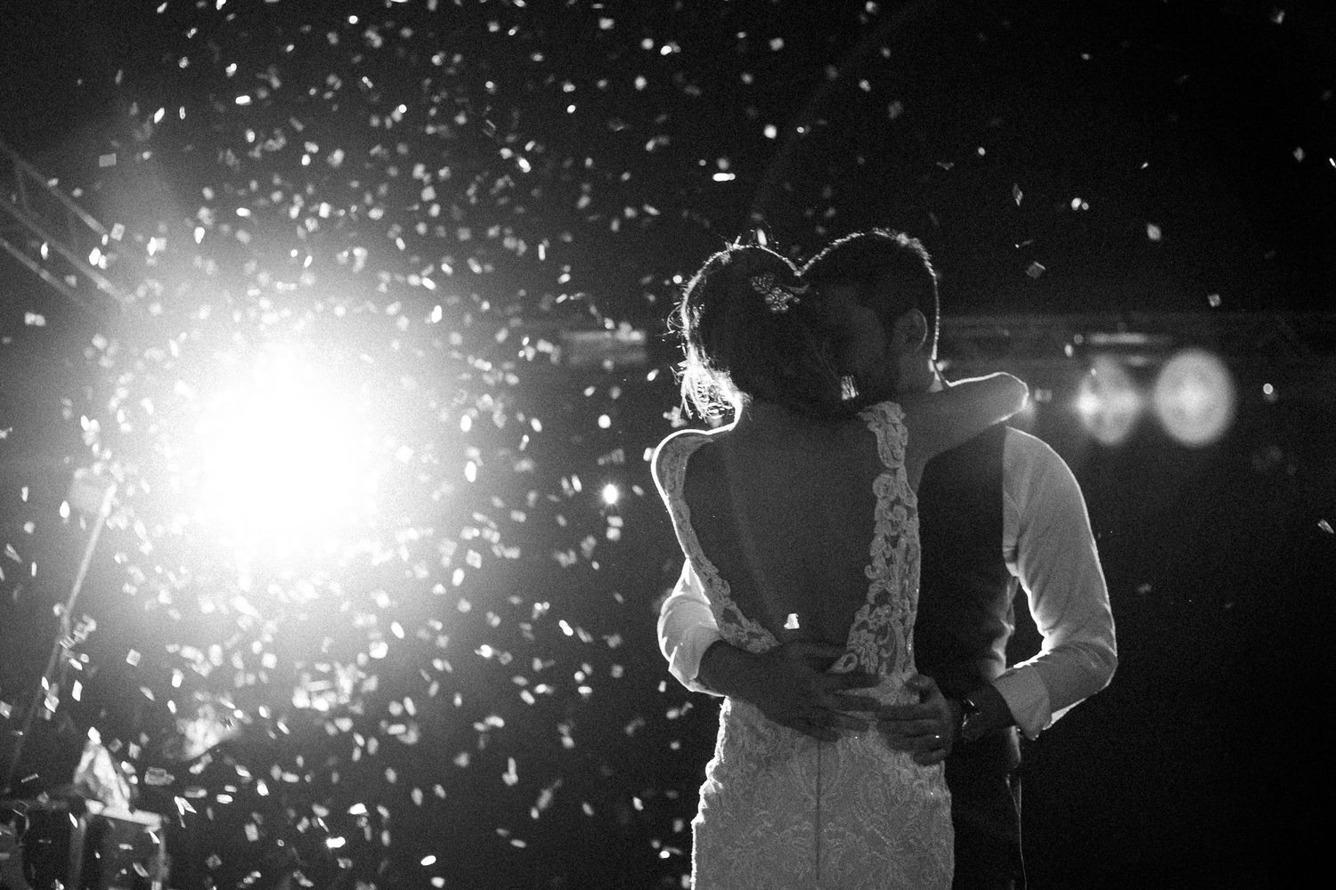 Multiple black and white photos of sparkling sparklers creating bright trails of light against dark backgrounds.
