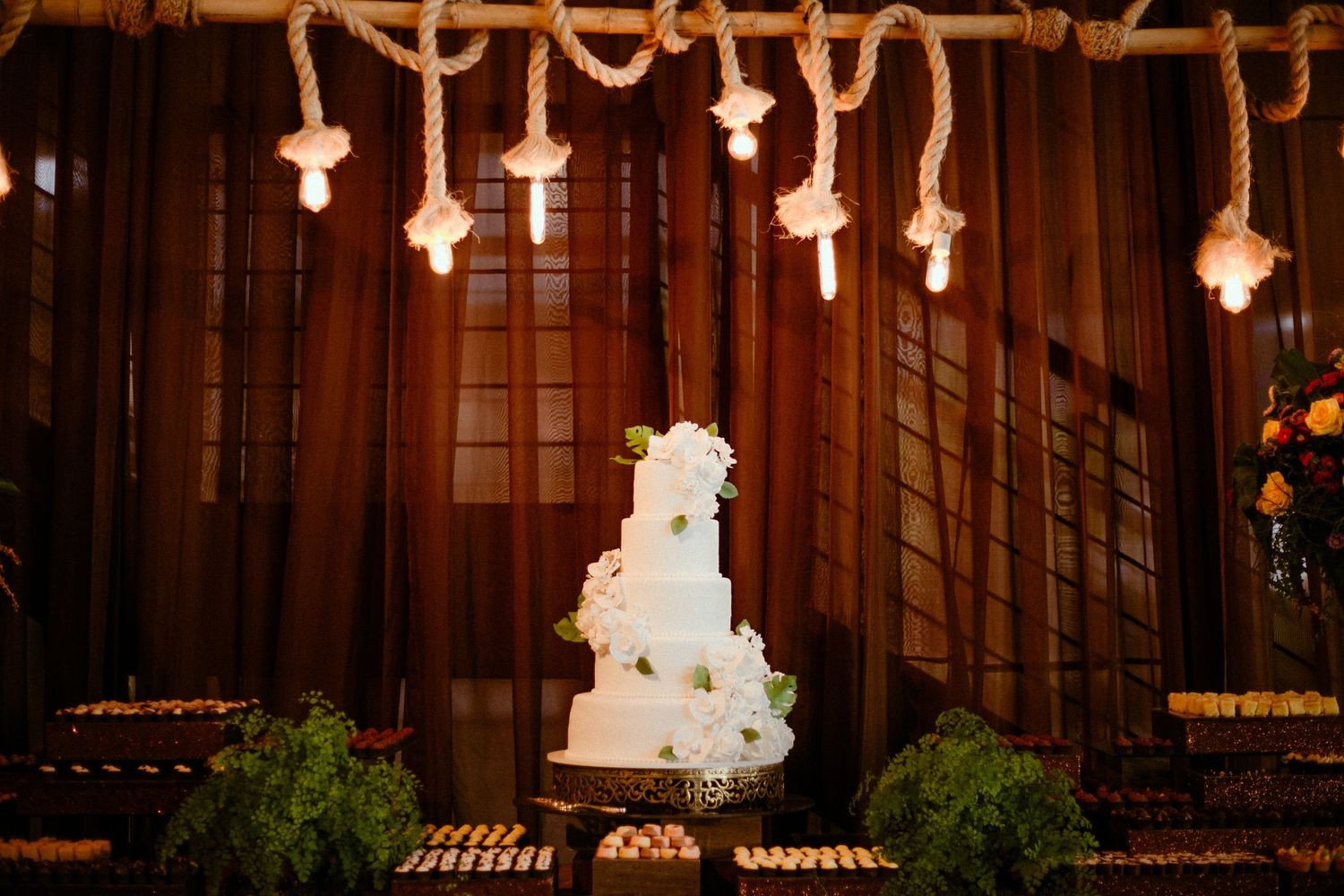 A rustic cabin altar decorated with glowing crosses and greenery for a wedding ceremony against wooden paneling.
