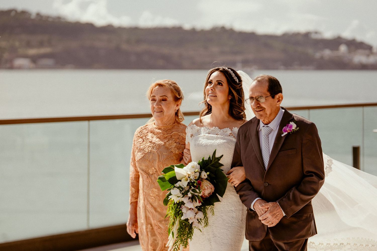 Outdoor wedding ceremony overlooking a scenic waterfront view.