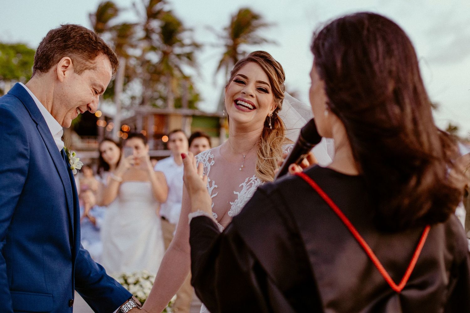 A joyful wedding celebration with guests reacting emotionally during the ceremony.