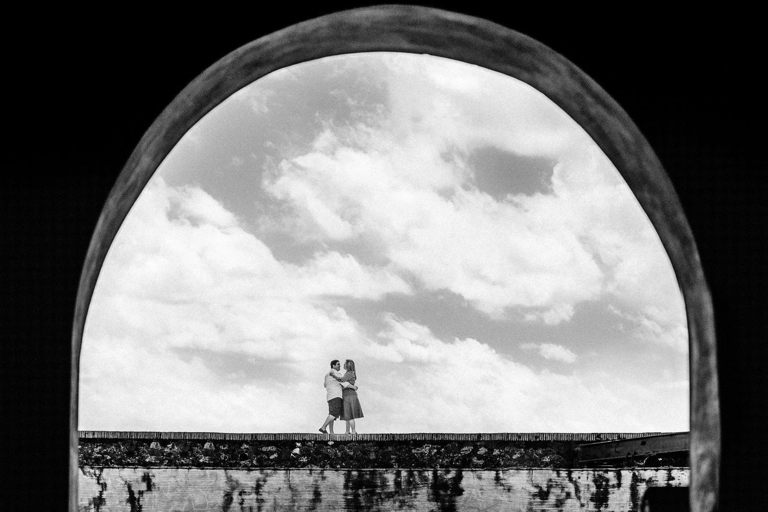 Low angle view through stone arch of a lighthouse against cloudy sky at El Morro fortress in Puerto Rico.