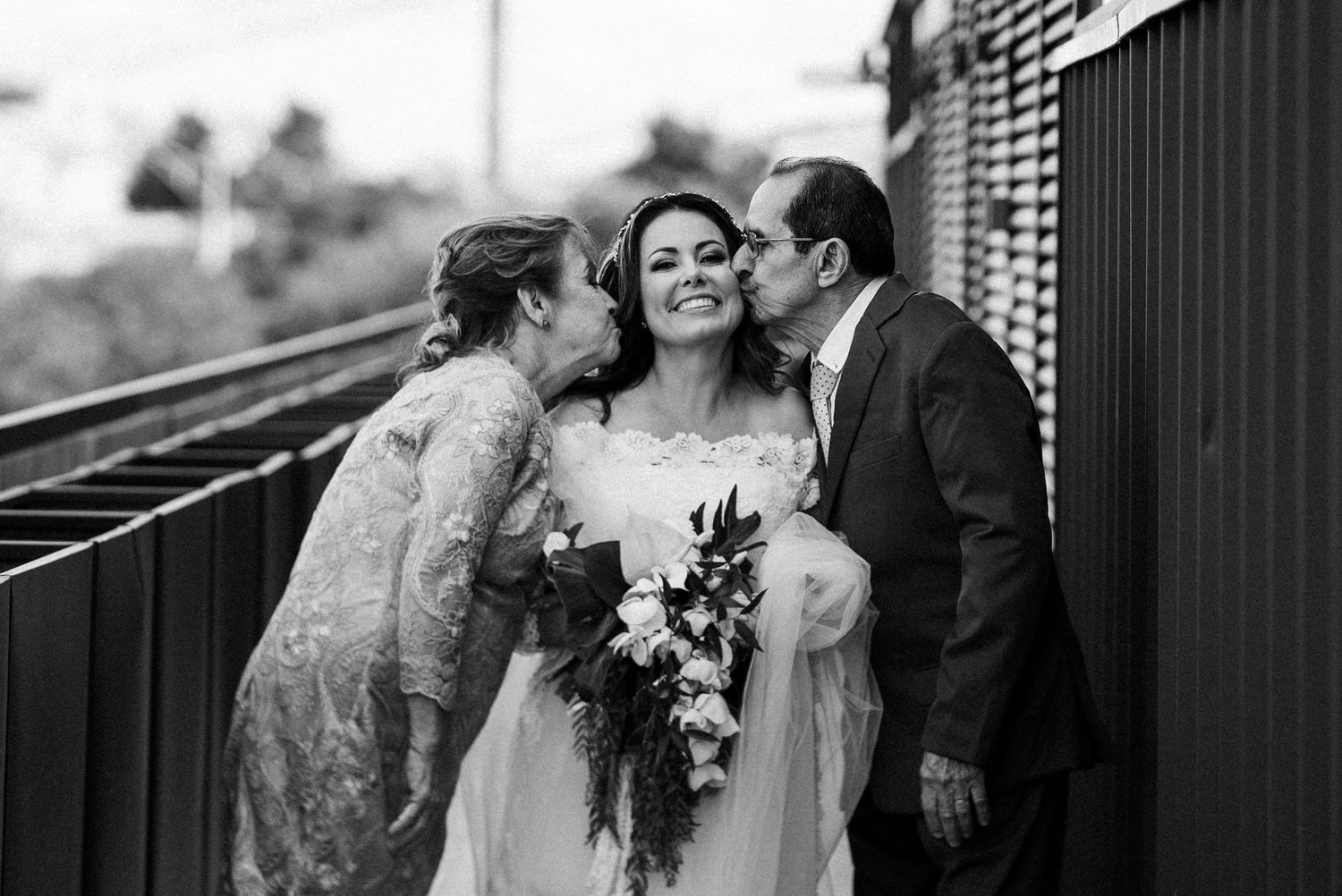 Black and white collage of candid wedding moments showing couples embracing and celebrating their special day.
