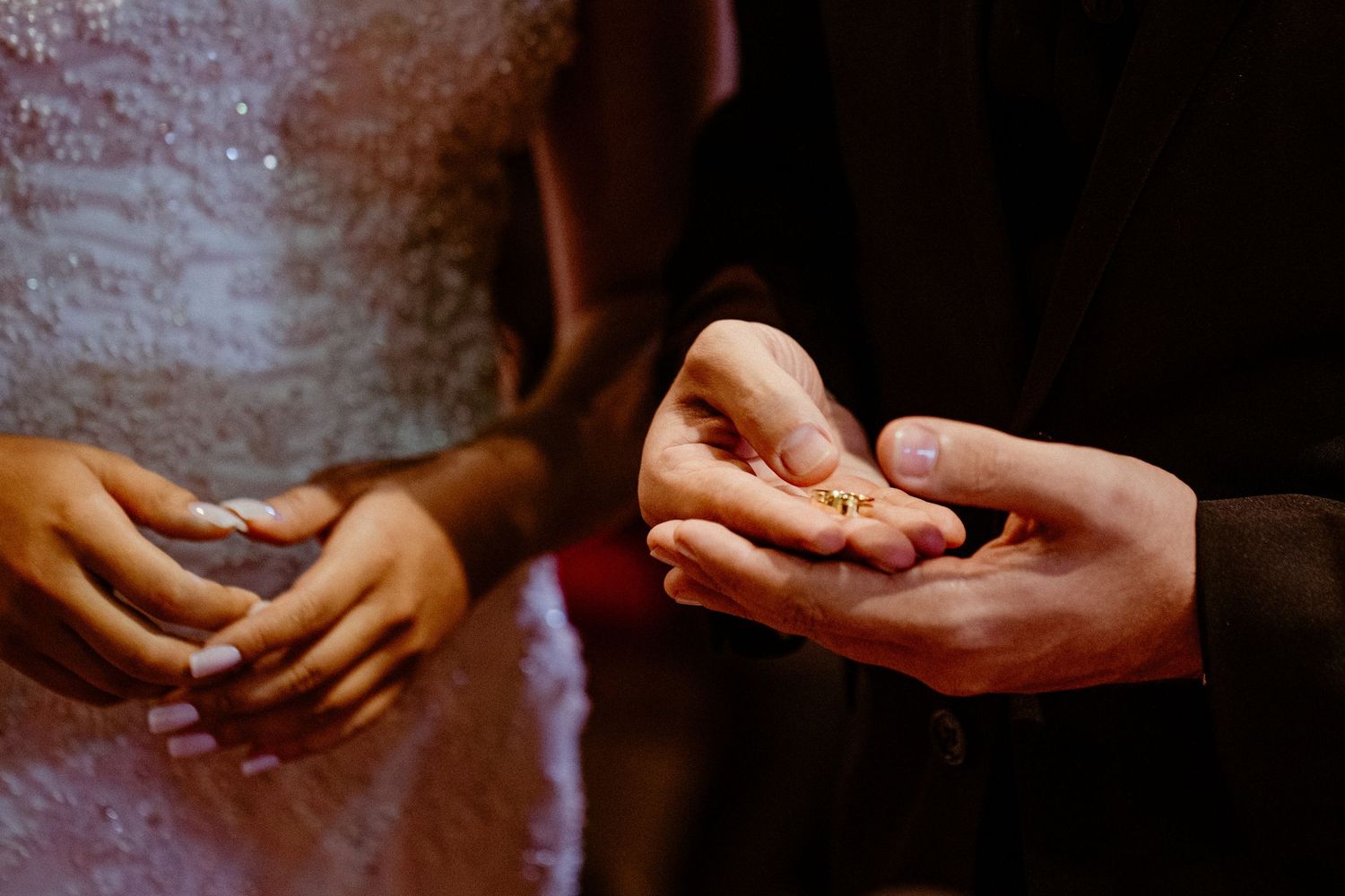 Artistic close-up series of hands detailing an intimate moment during a wedding ceremony.