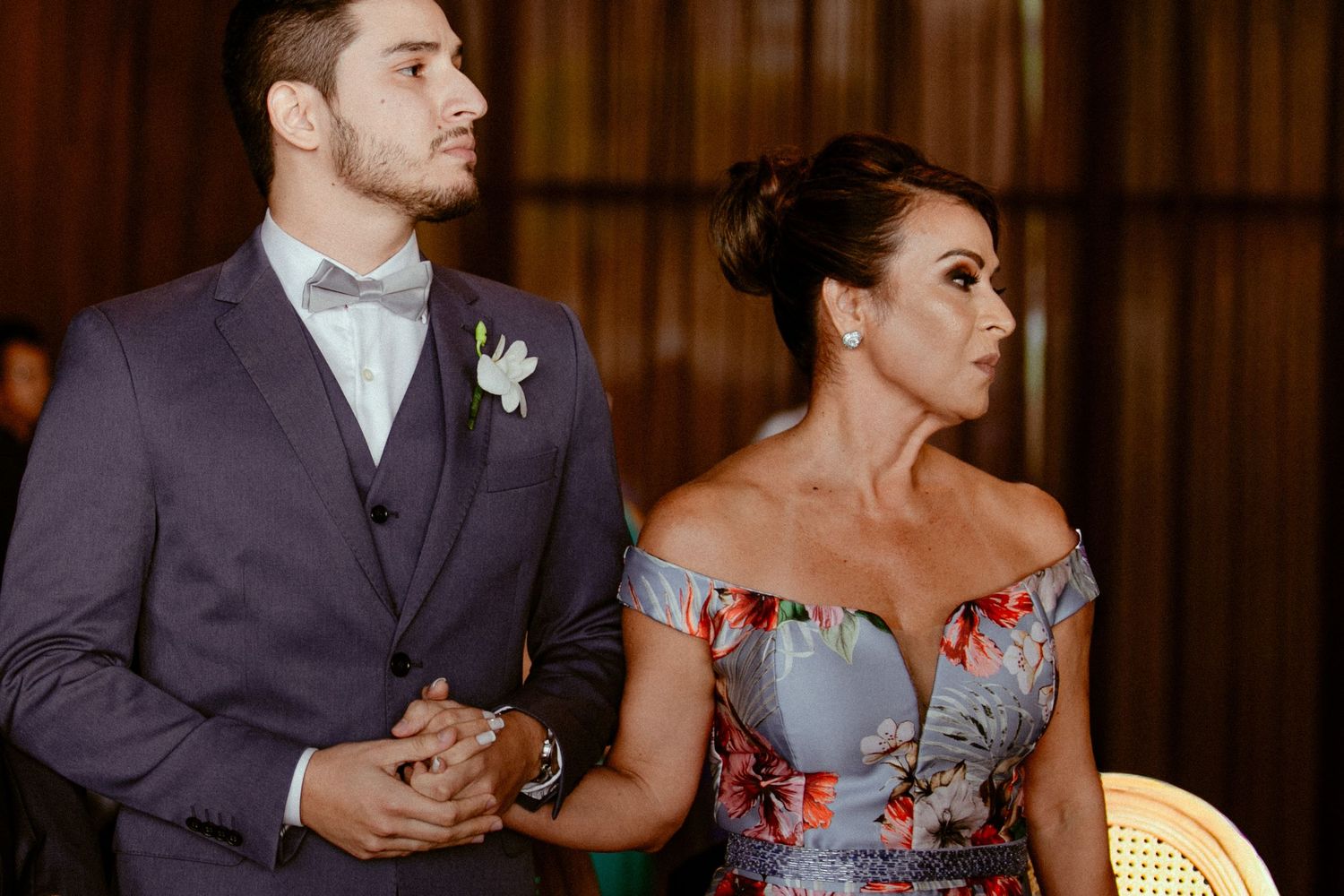 Wedding guests dancing and celebrating on a dance floor at an evening reception.