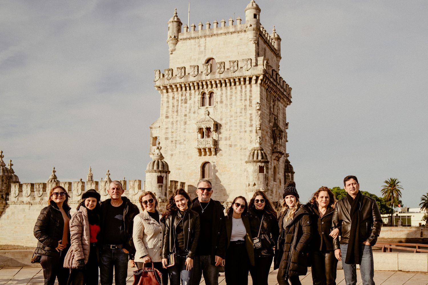 A group poses in front of the historic Belem Tower in Lisbon, Portugal.