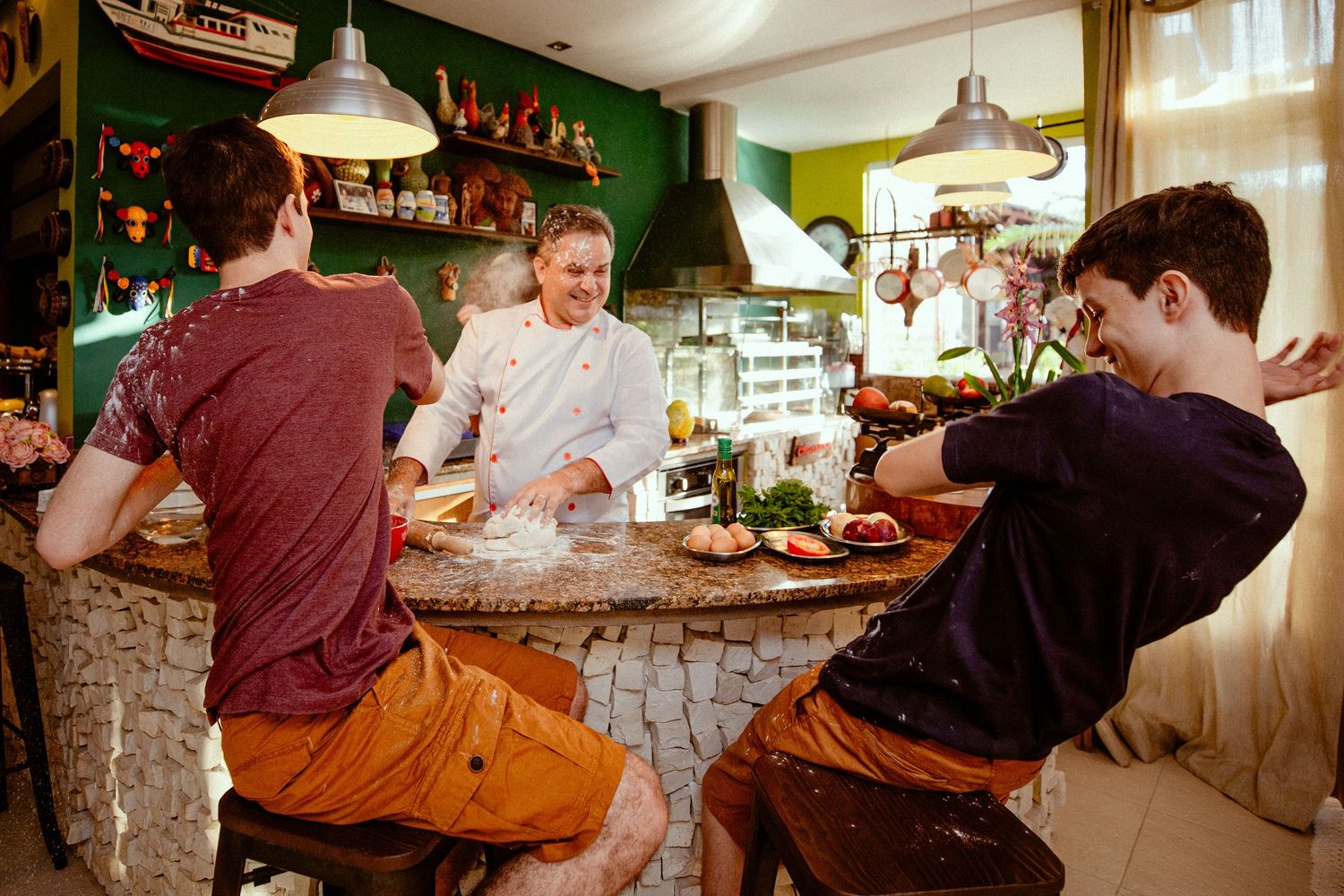 Interior view of a busy restaurant counter showing diners seated at a bar enjoying their meals and drinks.
