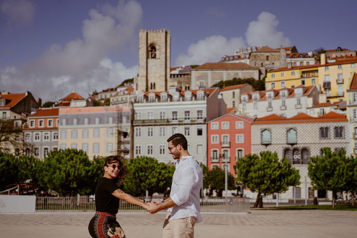 A romantic couple explores the charming streets and architecture of Lisbon, Portugal in a multi-photo series.