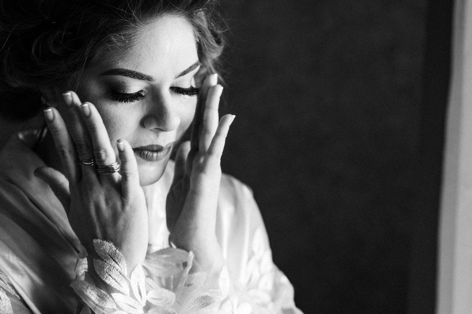 A series of black and white portrait photographs showing emotional expressions through hand gestures and poses.