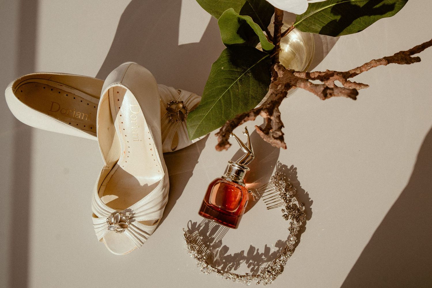 Wedding jewelry and accessories including crowns, earrings, hair clips and other delicate pieces displayed on textured surfaces.