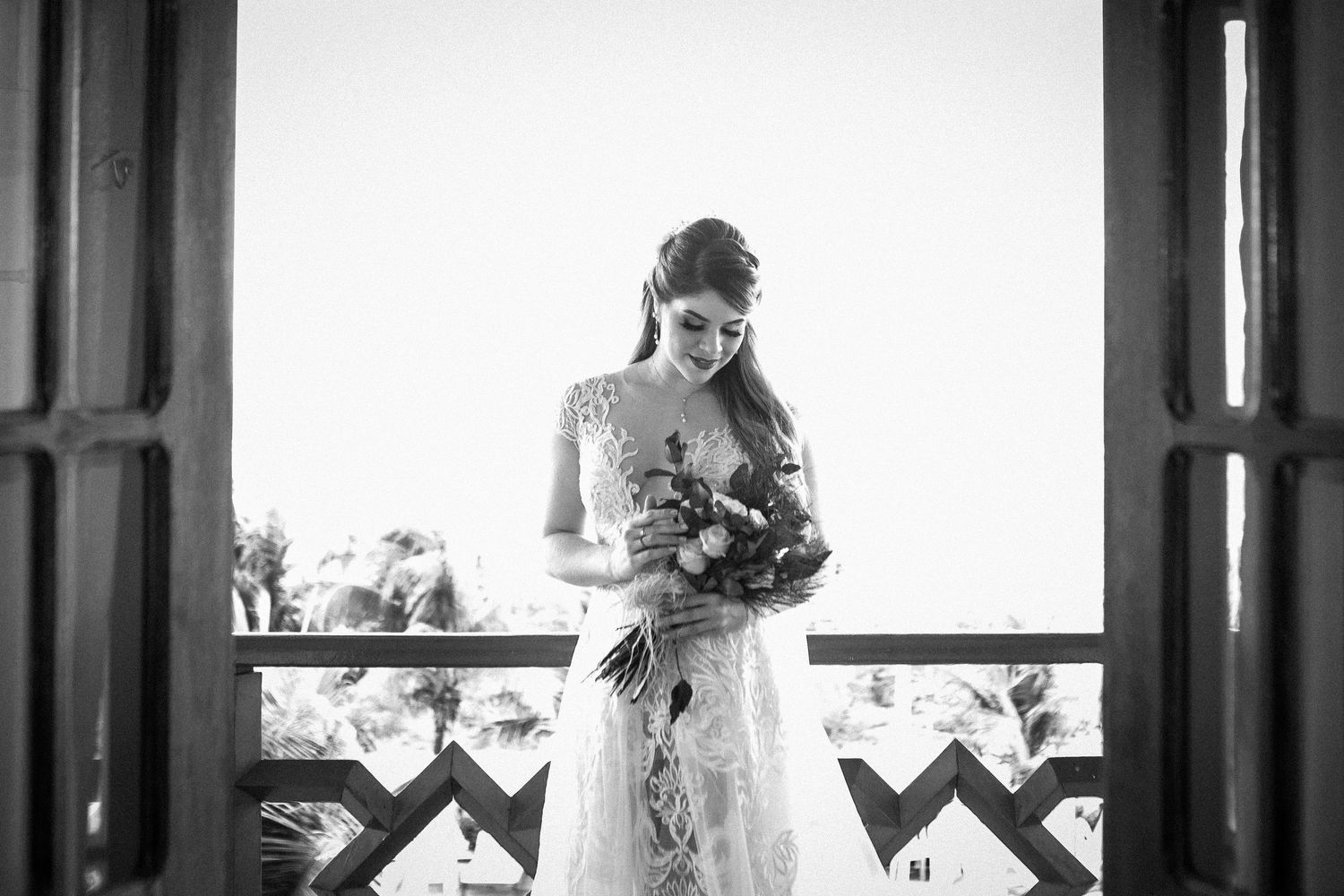 Black and white wedding photo collage showing bride in elegant dress looking out windows in various romantic poses.