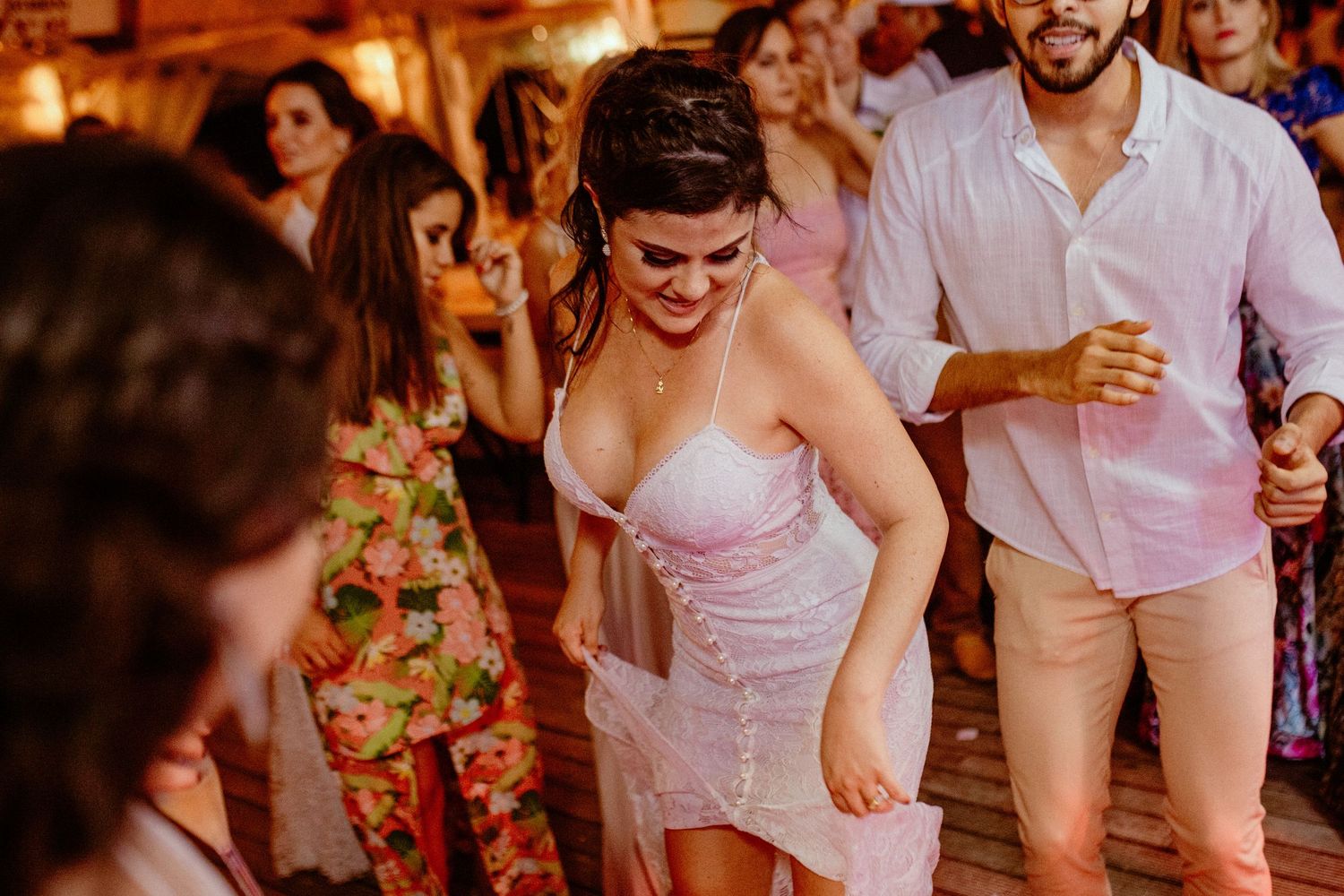 Lively wedding reception party with guests celebrating on the dance floor.