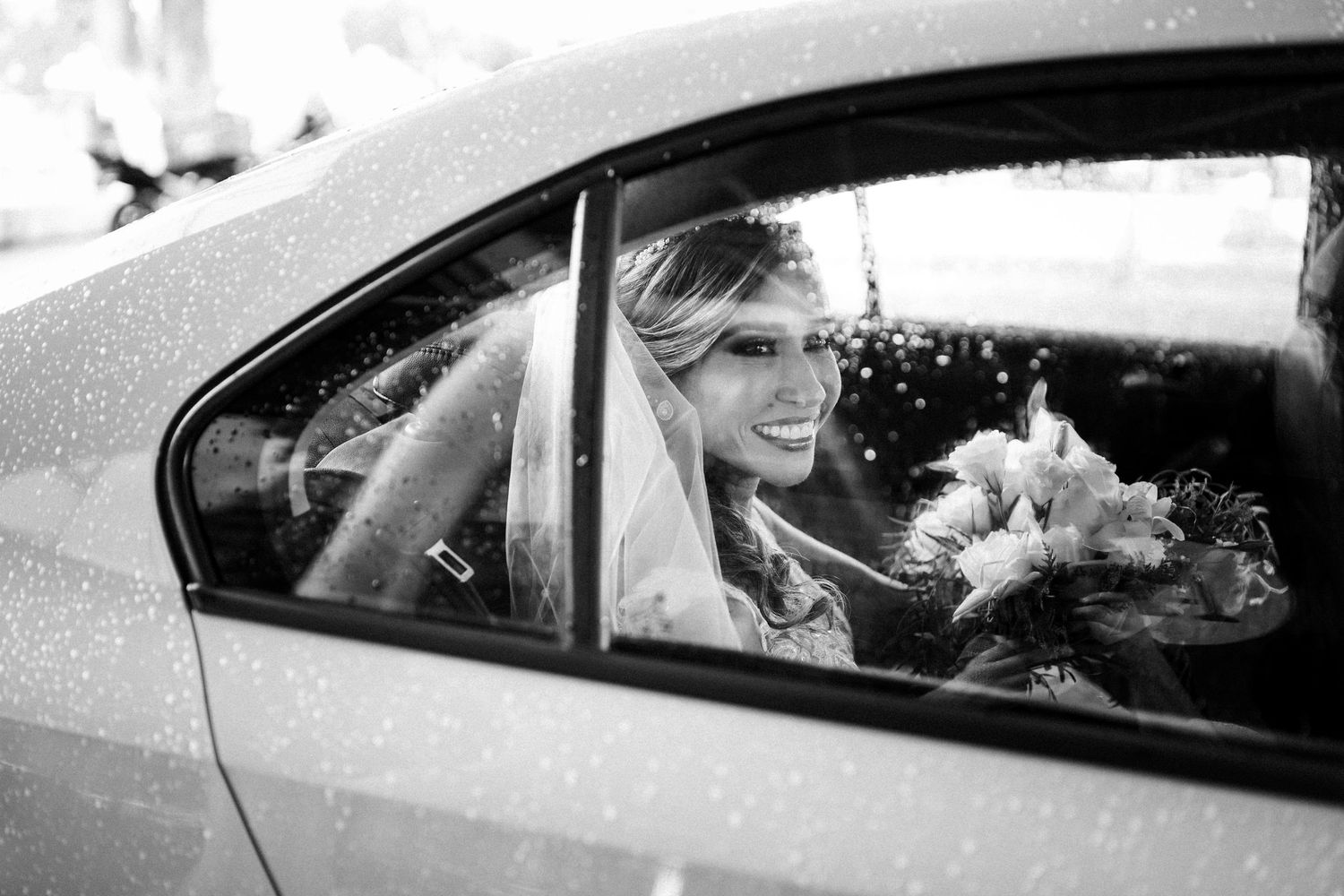 Black and white wedding photos showing happy people in cars celebrating after the ceremony.