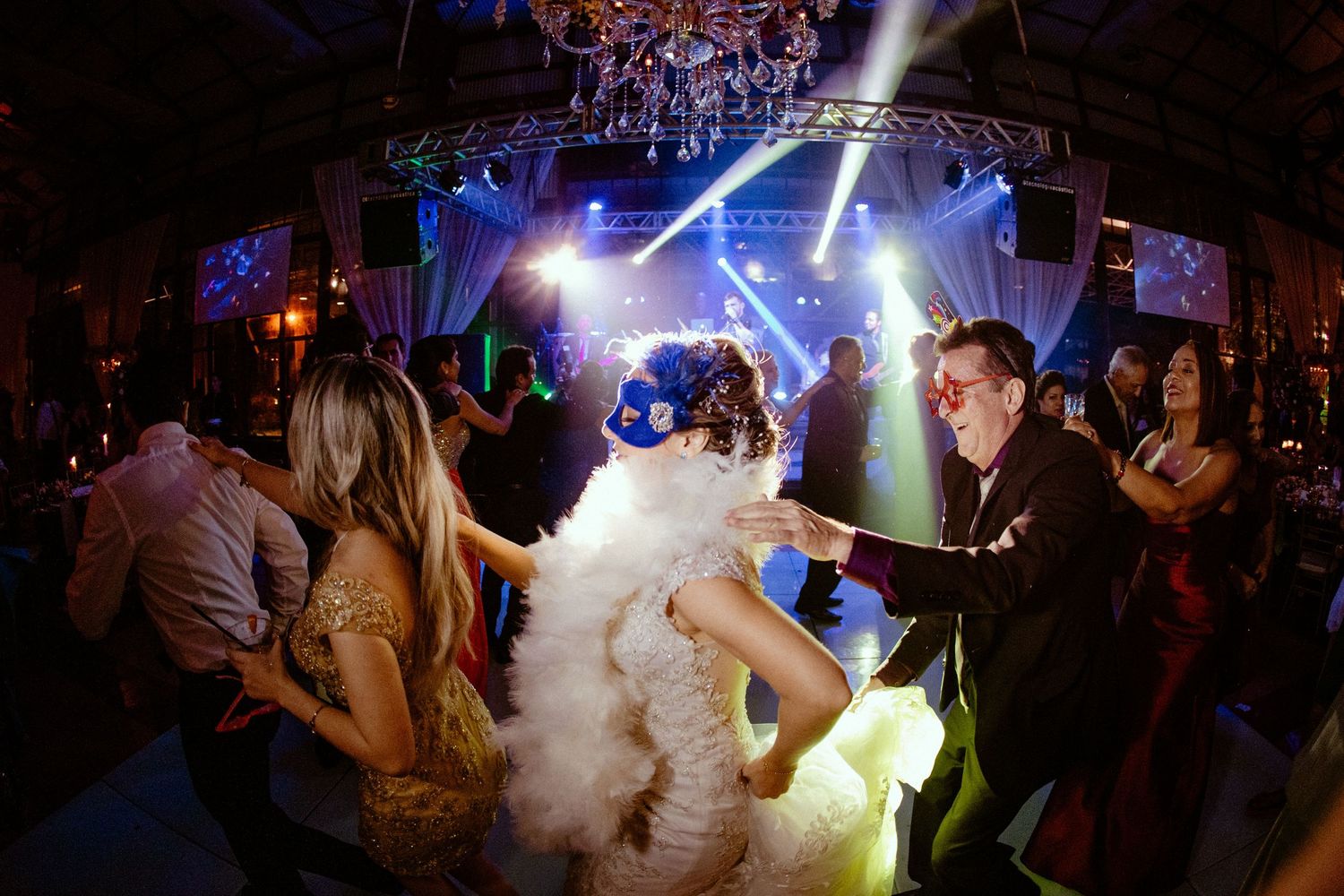 Nightclub dance floor scene with dramatic lighting effects and fog machine creating an energetic atmosphere.