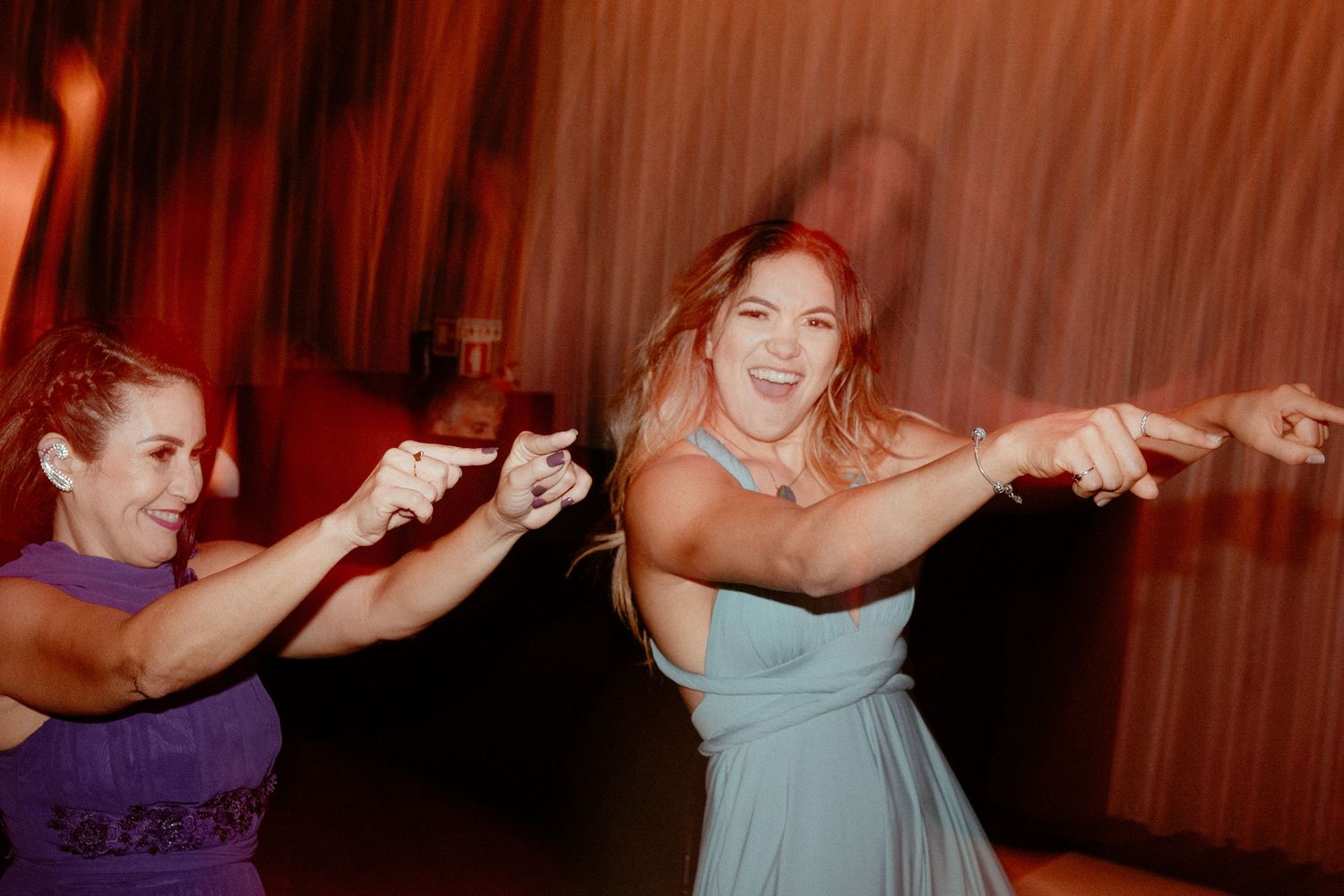 A sequence of vintage-style dance party photos shows people moving and dancing under red lighting.