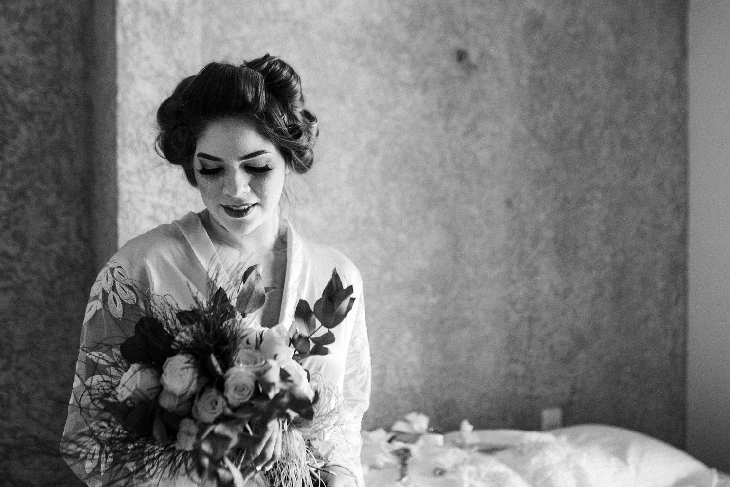 A series of soft black and white portraits featuring vintage-styled figure among romantic floral arrangements.