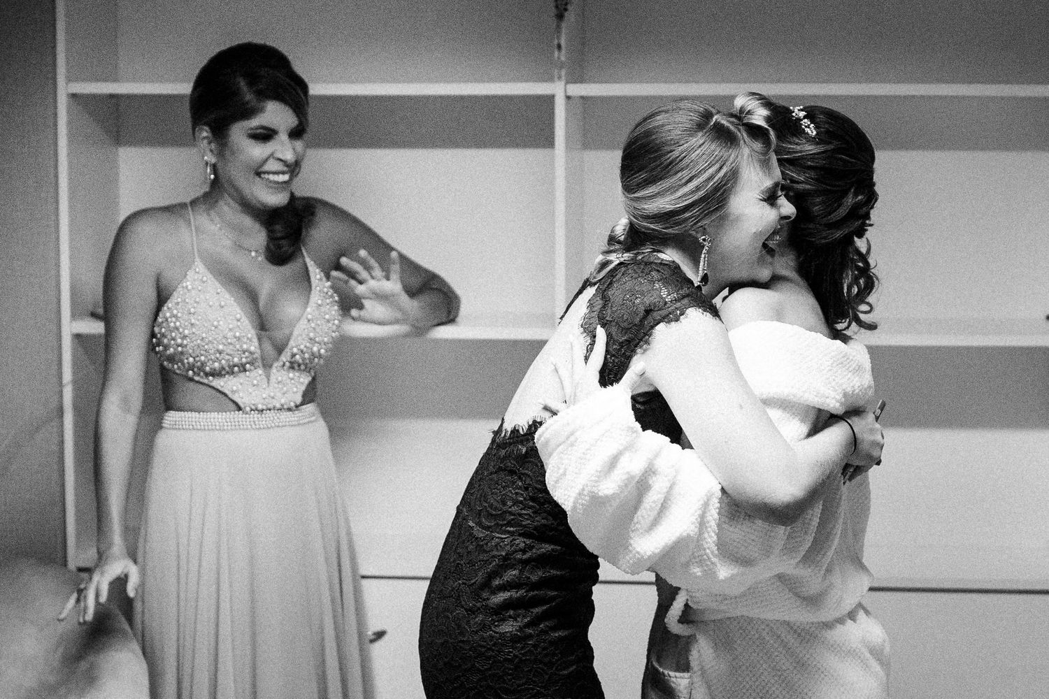 Black and white candid wedding photos show people dancing and celebrating during a reception.