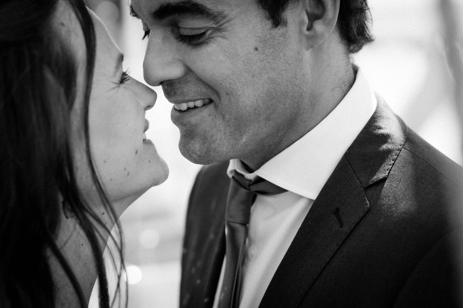 Black and white romantic photo sequence showing a couple in formal attire sharing intimate moments together.