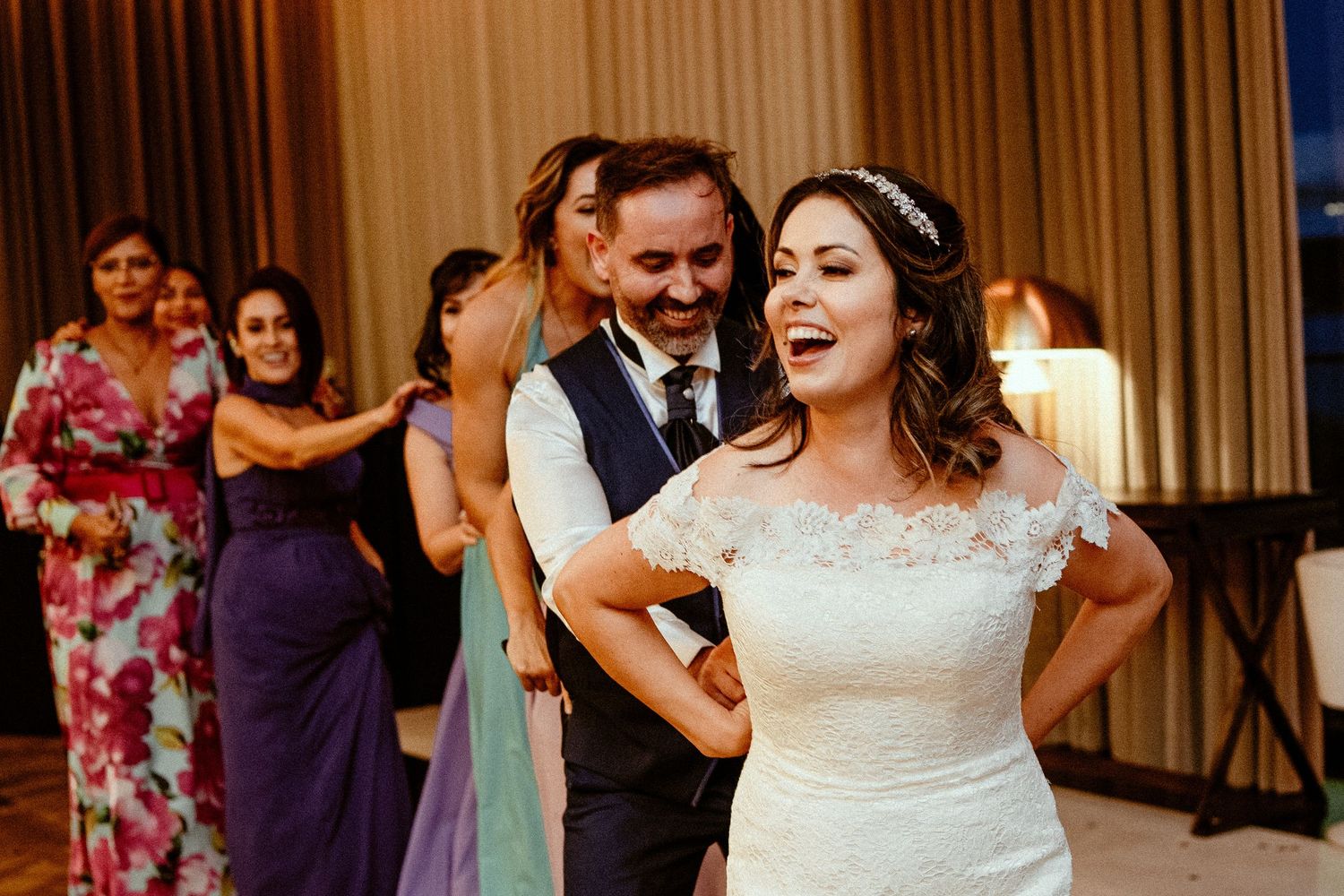 Joyful dancing and celebration during wedding reception with colorful decor.