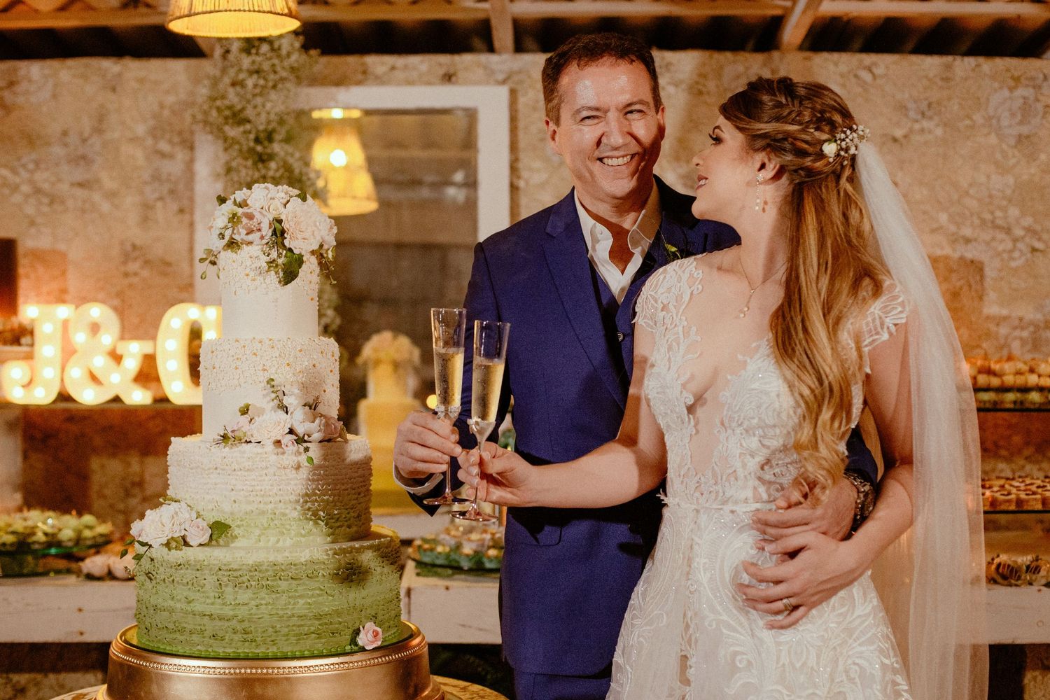 Couple shares romantic moments during their wedding reception in a rustic venue with exposed brick walls and warm lighting.