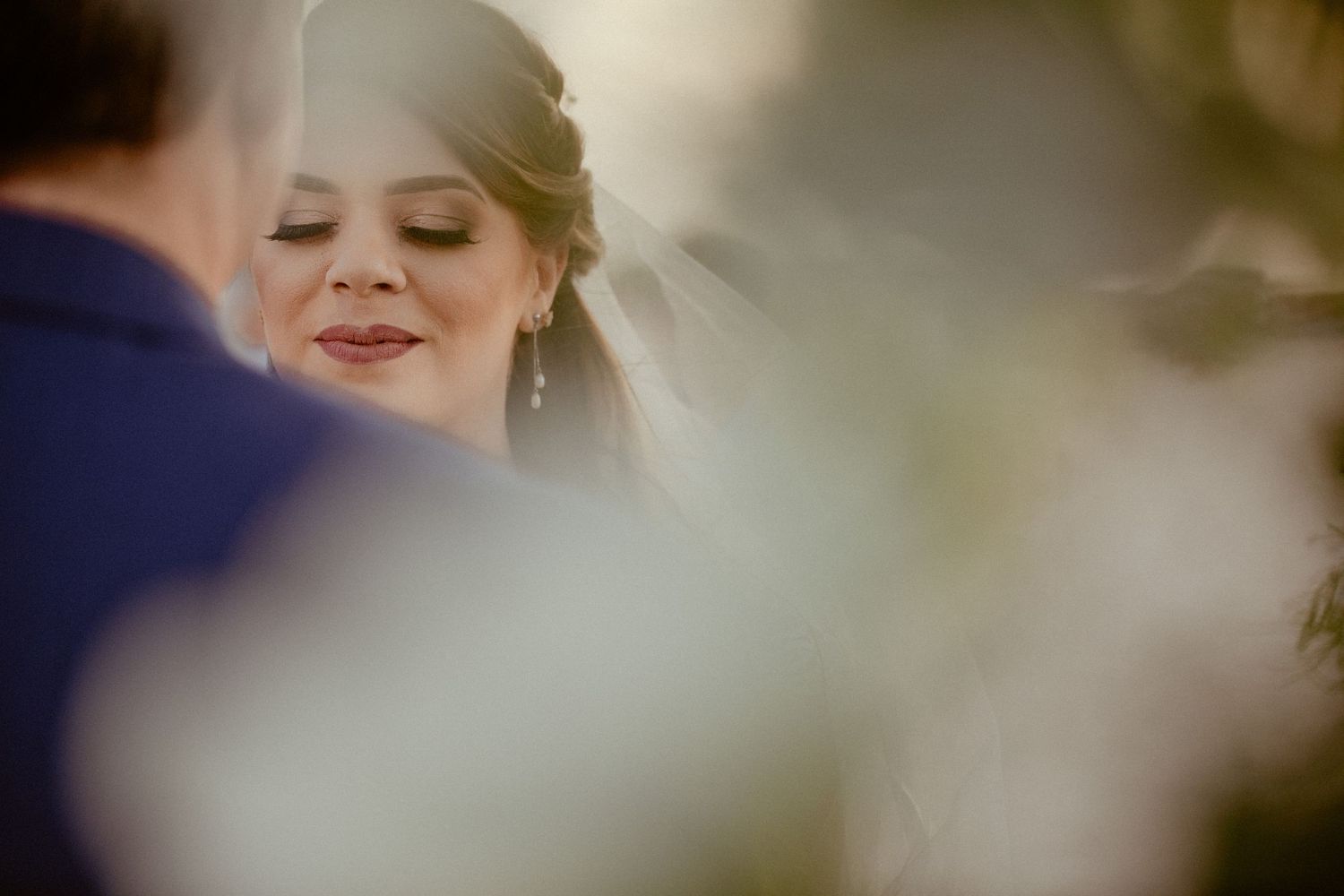 Seven blurry wedding photos arranged horizontally showing romantic moments between a couple during their ceremony.