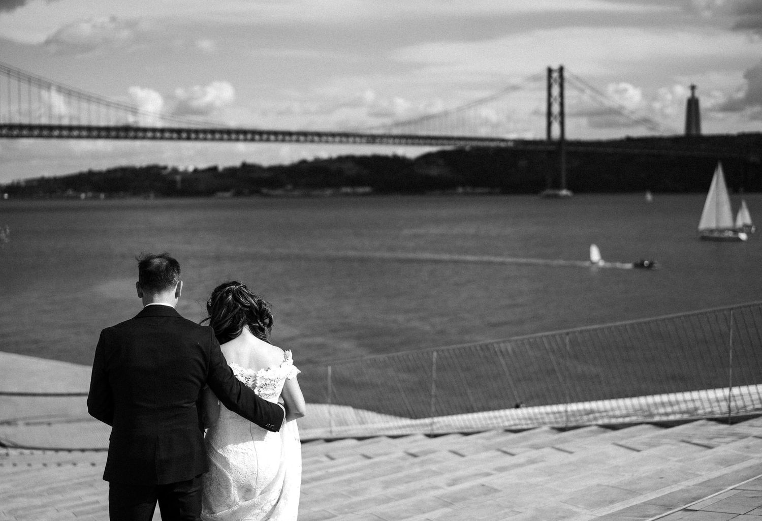 Couple admires the view of the Golden Gate Bridge on their wedding day in black and white.