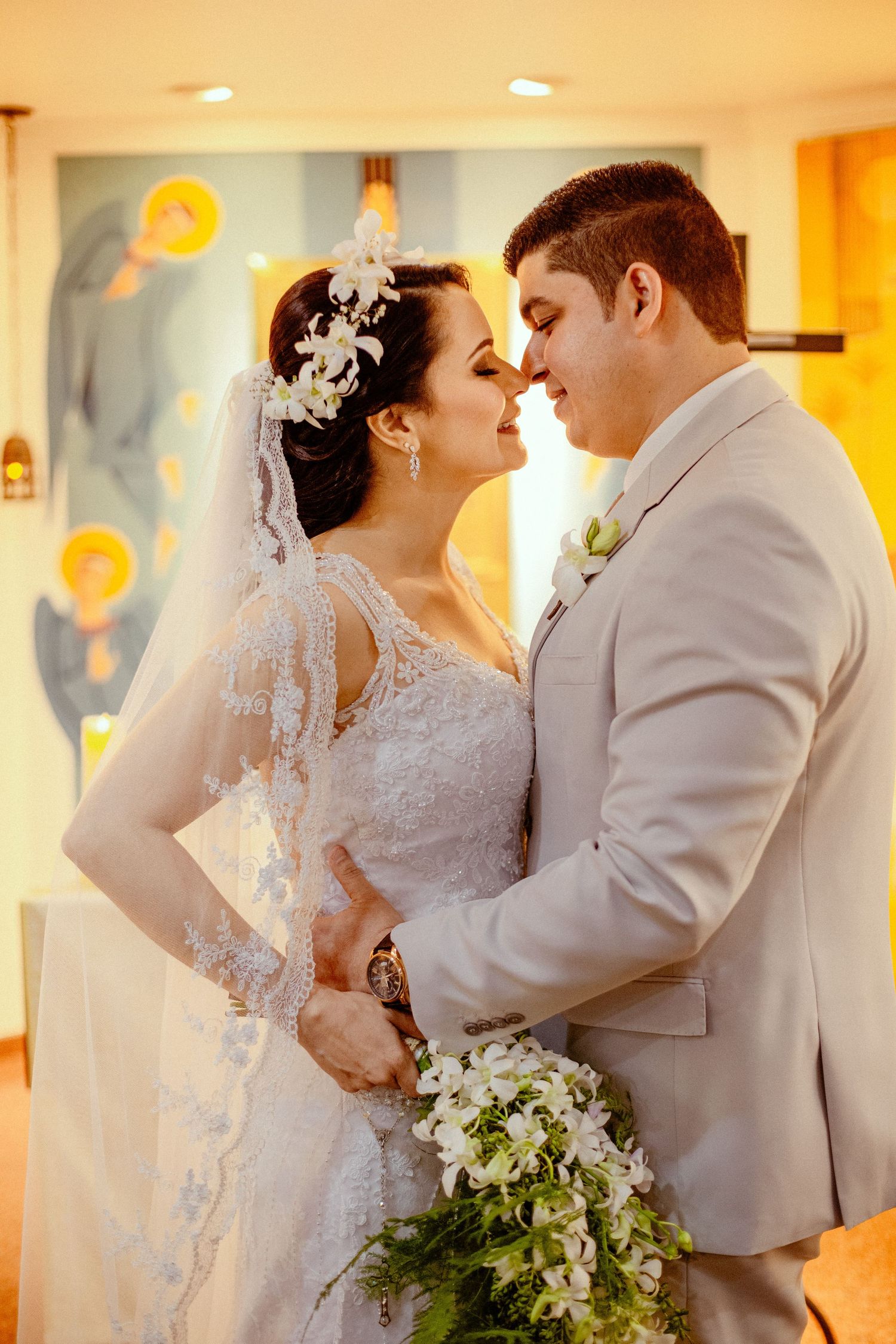 Romantic wedding portrait with couple in light-filled setting.