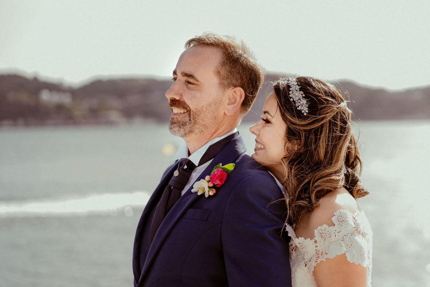 A bride and groom share tender moments by a scenic waterfront across multiple photos.
