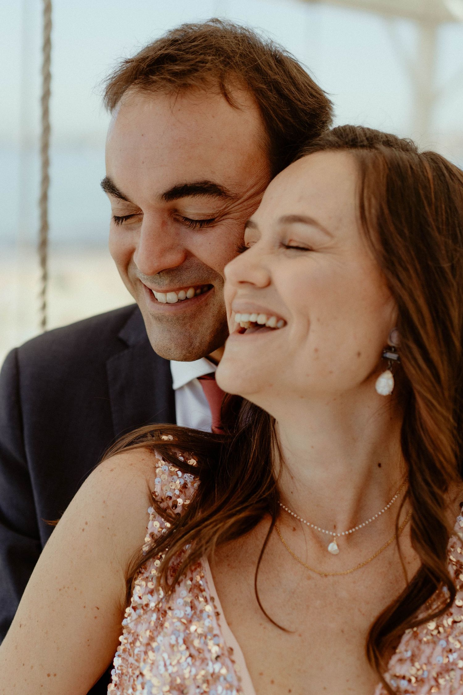 A happy couple shares intimate moments and laughter in a series of candid photos.