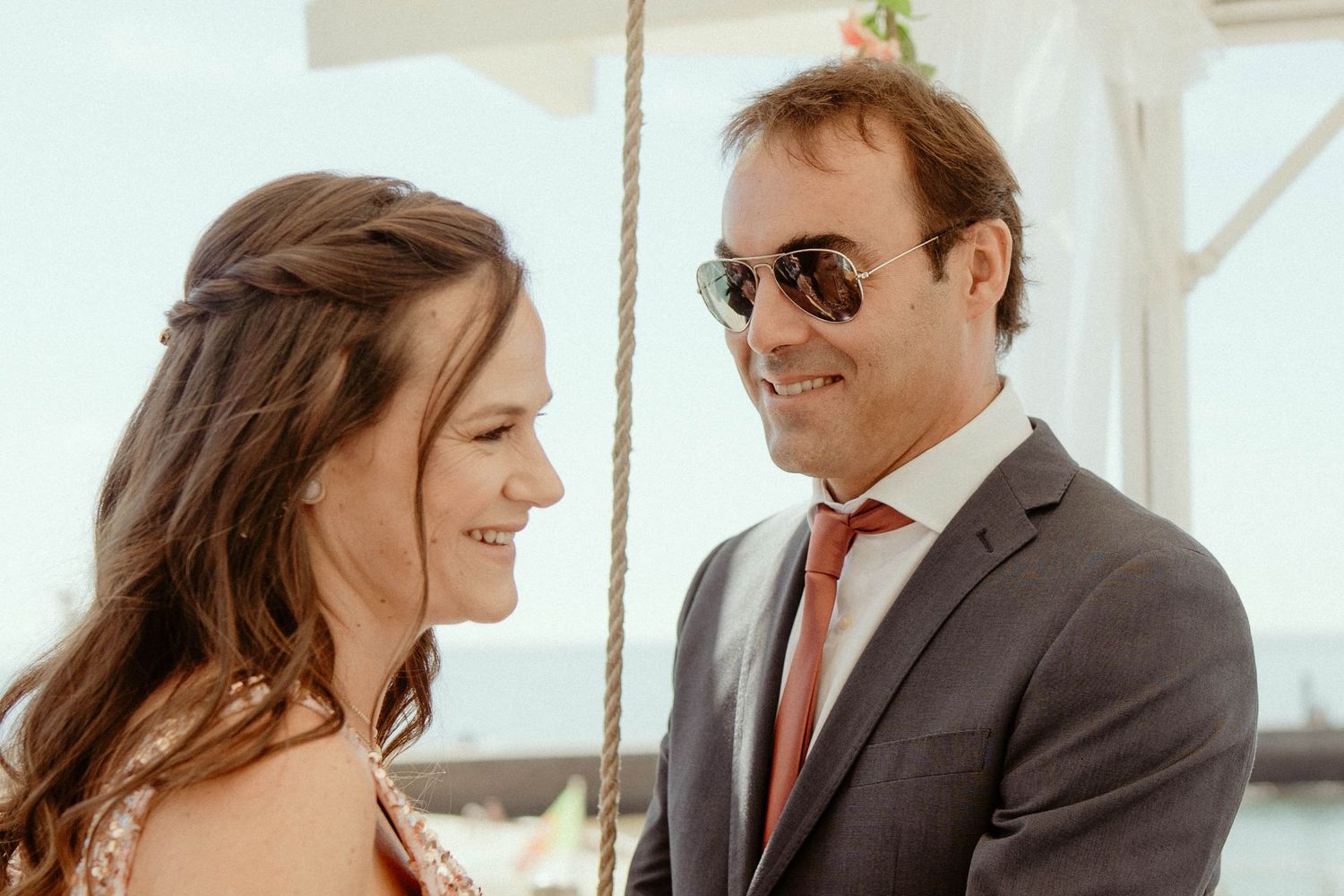 A couple shares joyful moments together in a sunlit indoor space with modern decor.