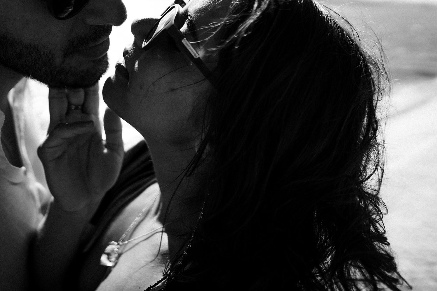 A black and white collage of silhouetted figures in candid poses and expressions.