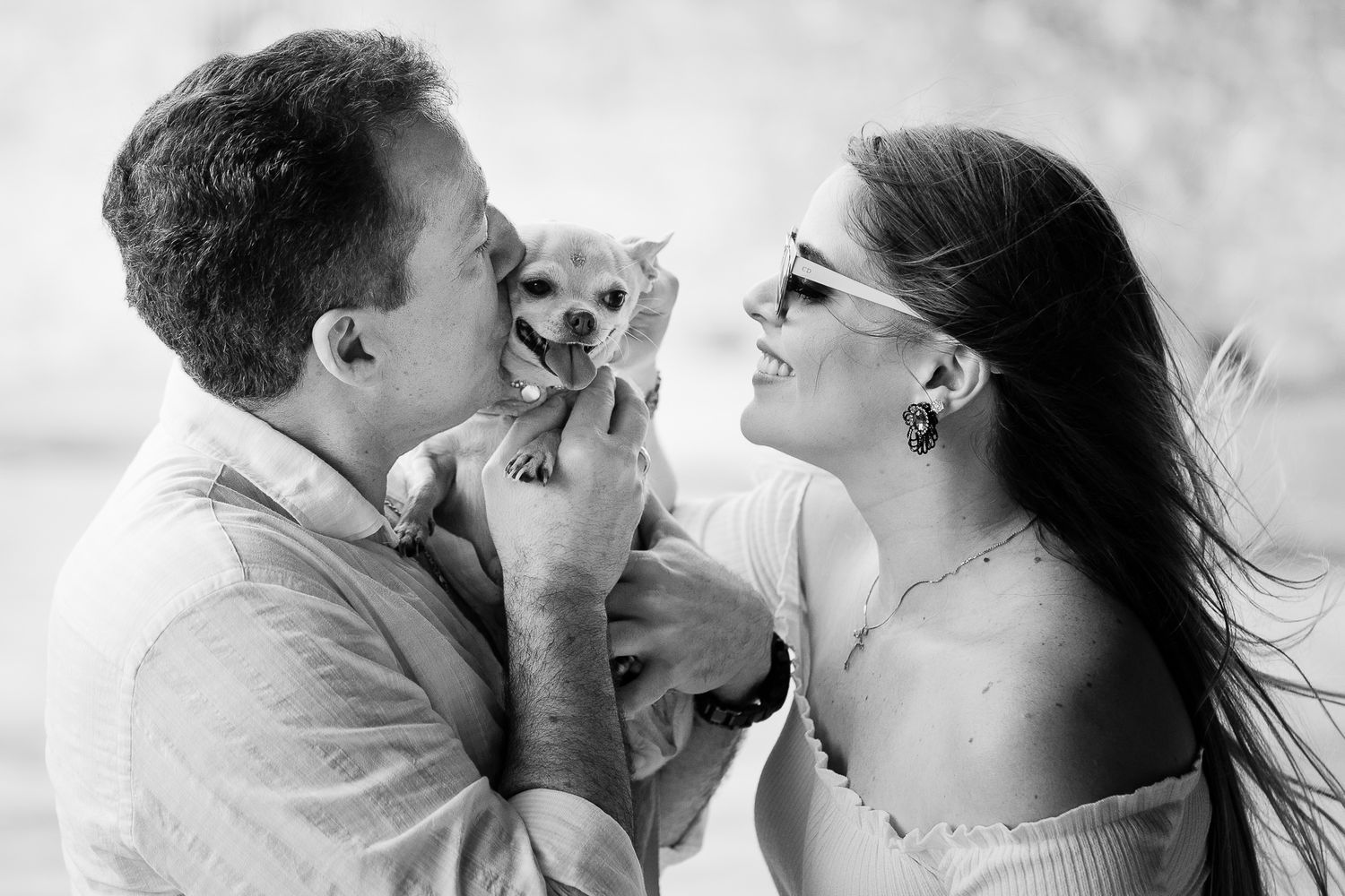 A romantic black and white photo series showing close-up moments of a couple kissing and embracing.