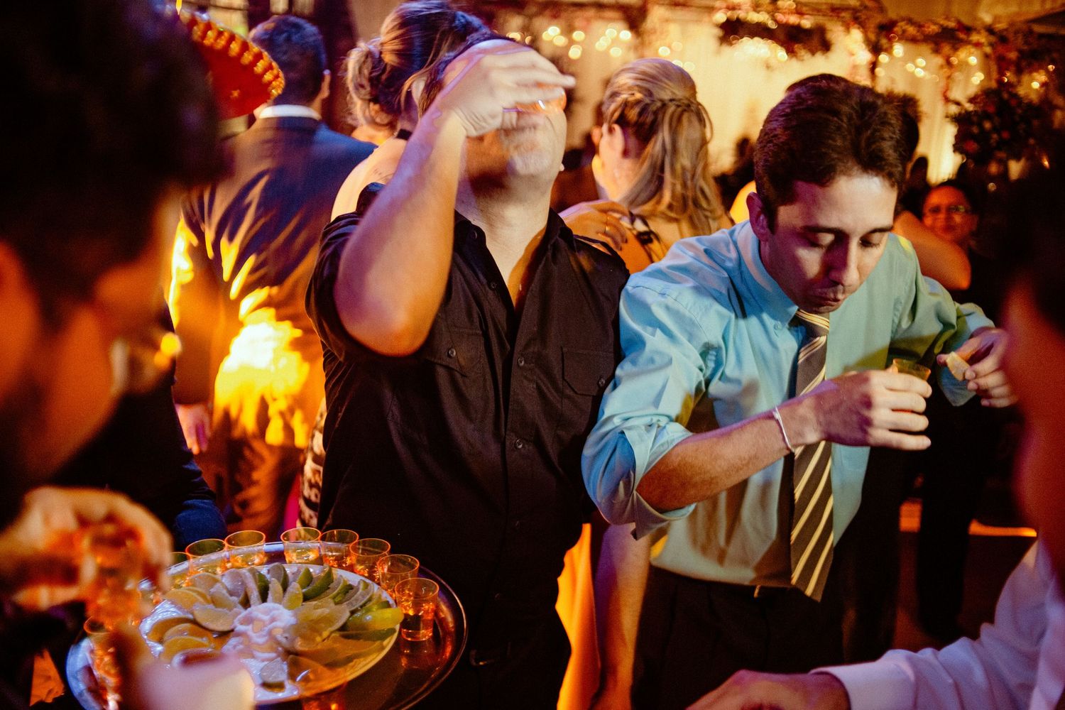 Wedding reception party scene with warm ambient lighting and festive atmosphere.