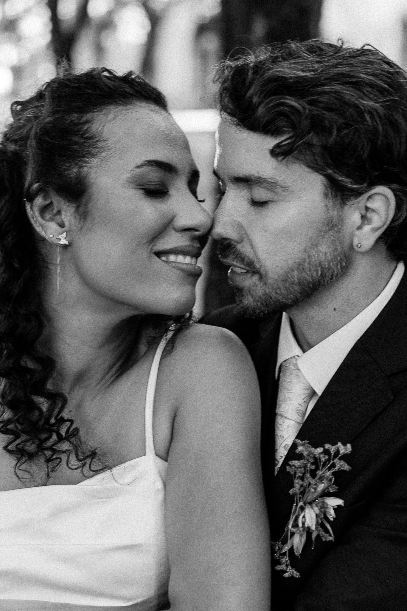 Black and white wedding portrait of smiling bride and groom sharing an intimate moment, cheek to cheek.