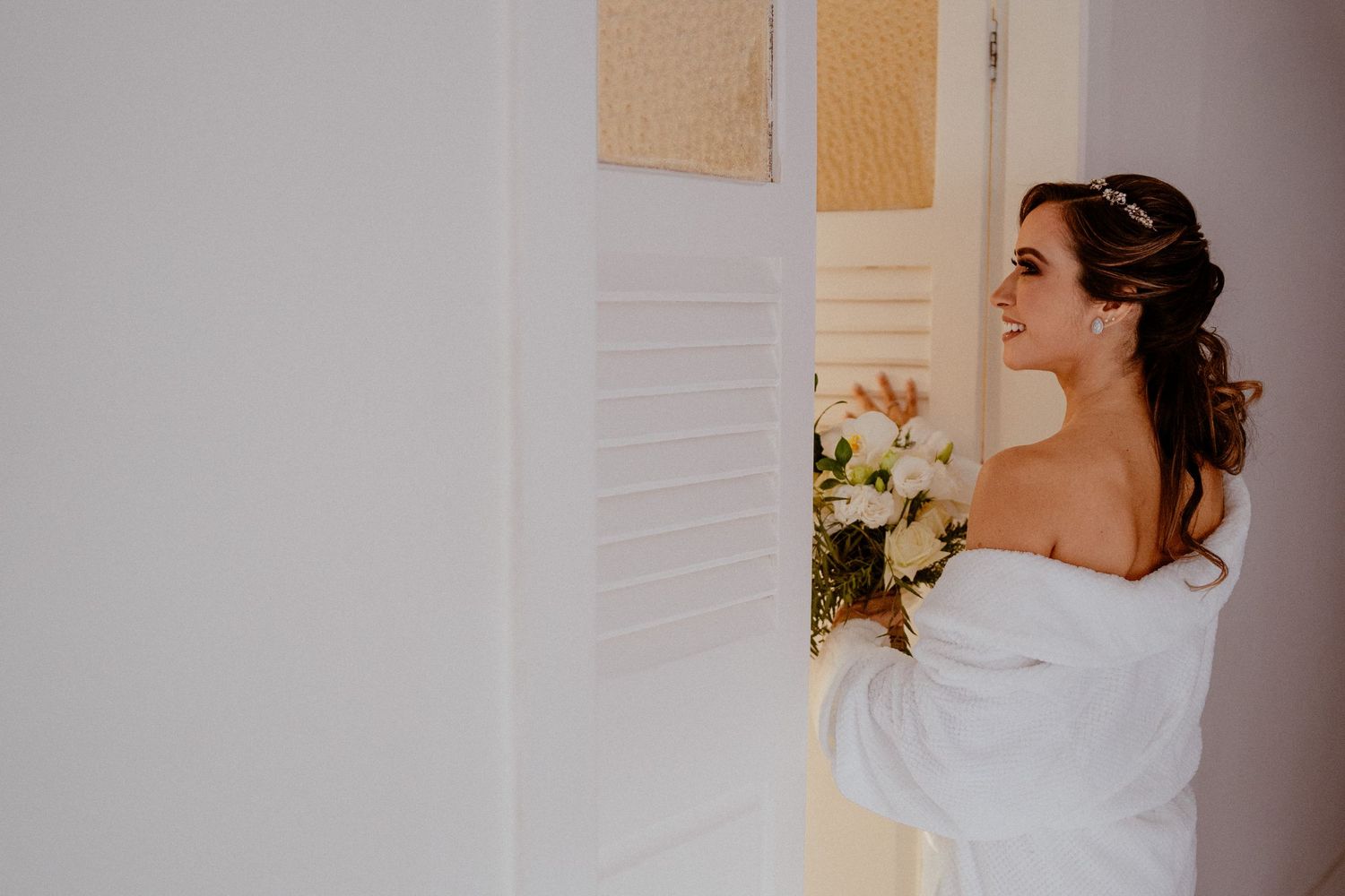 Bride and sister getting ready for wedding ceremony with hair and makeup preparations.