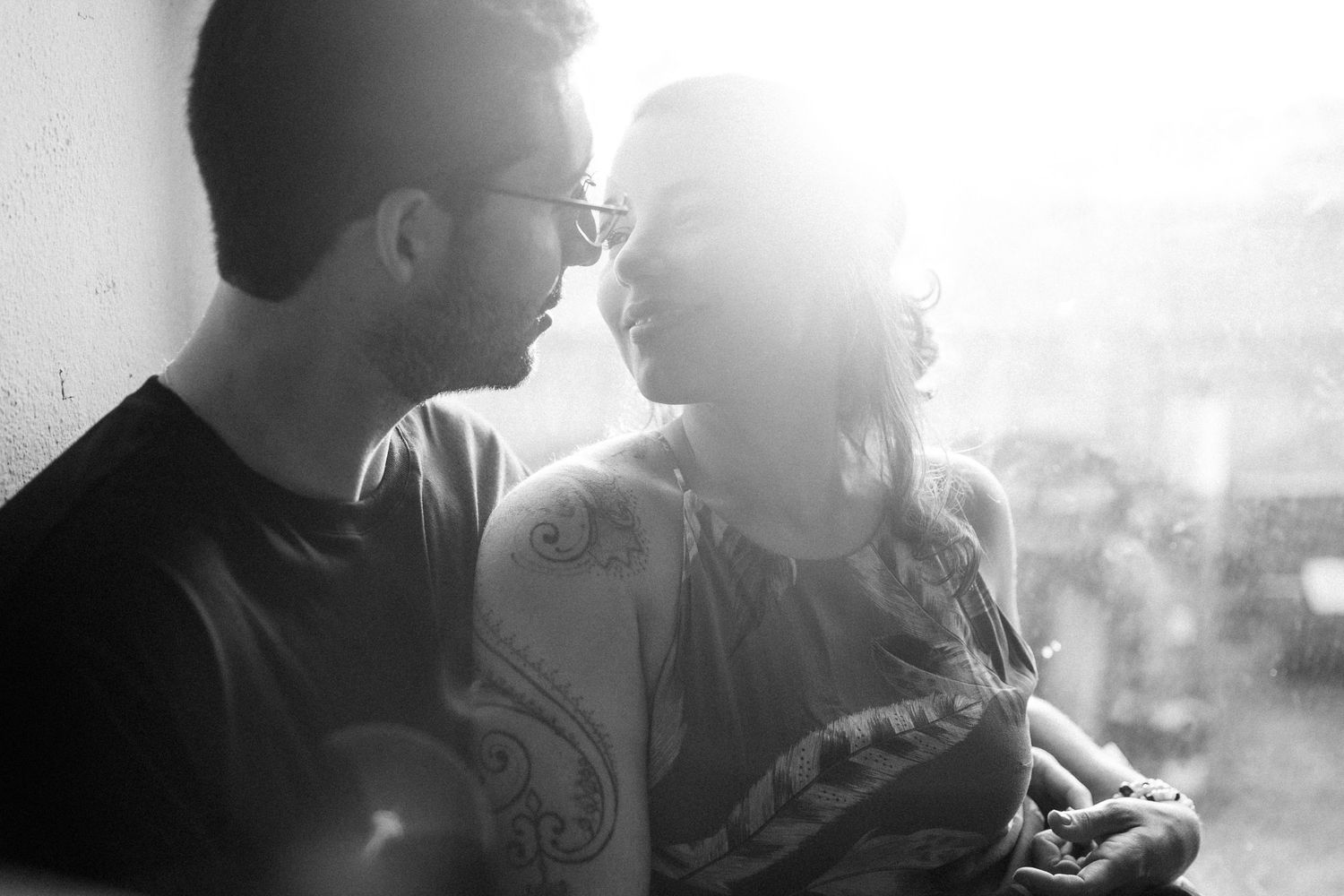 A series of silhouetted people hang out in atmospheric lighting during a social gathering.