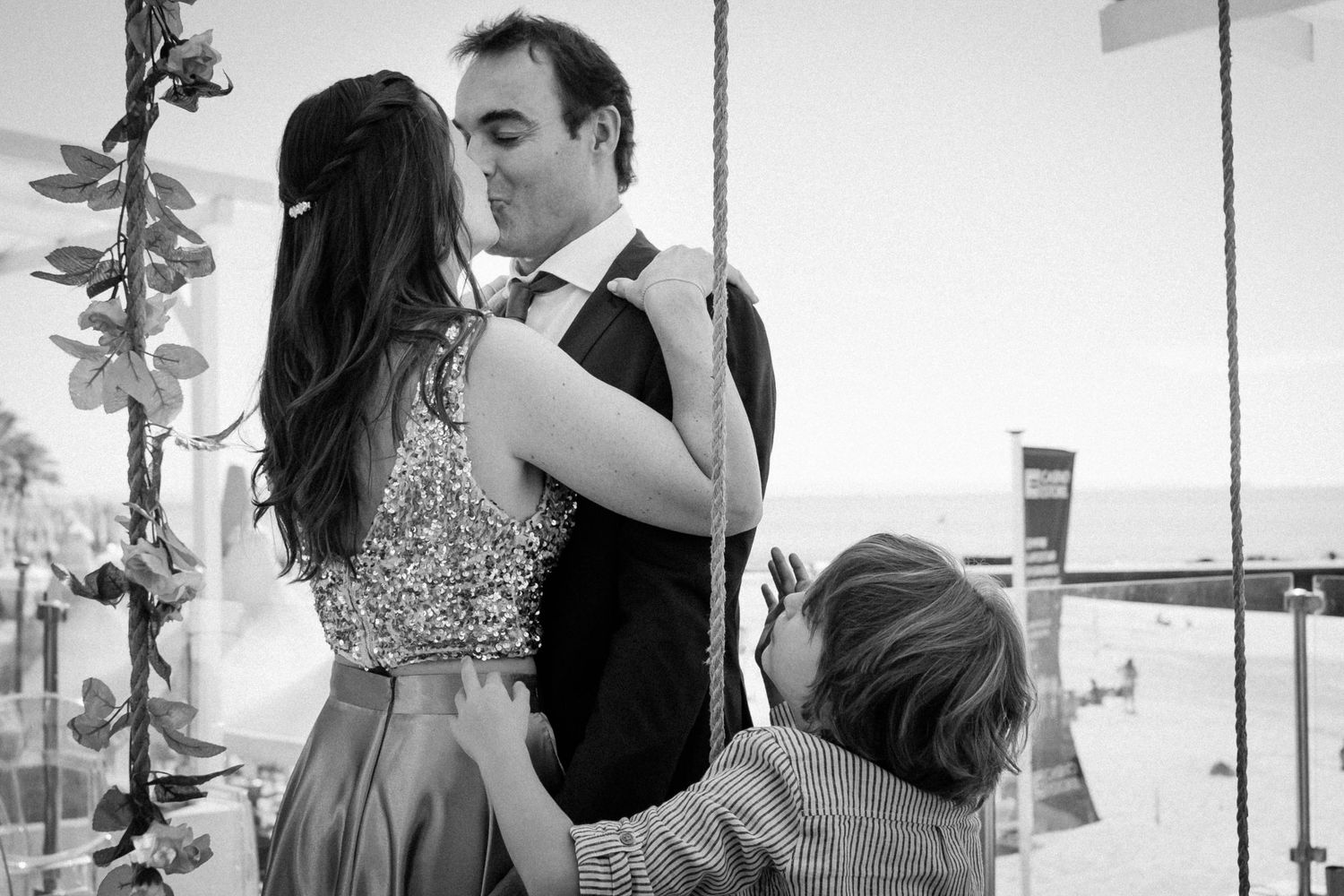 A romantic black and white collage of wedding moments showing intimate embraces and tender interactions.