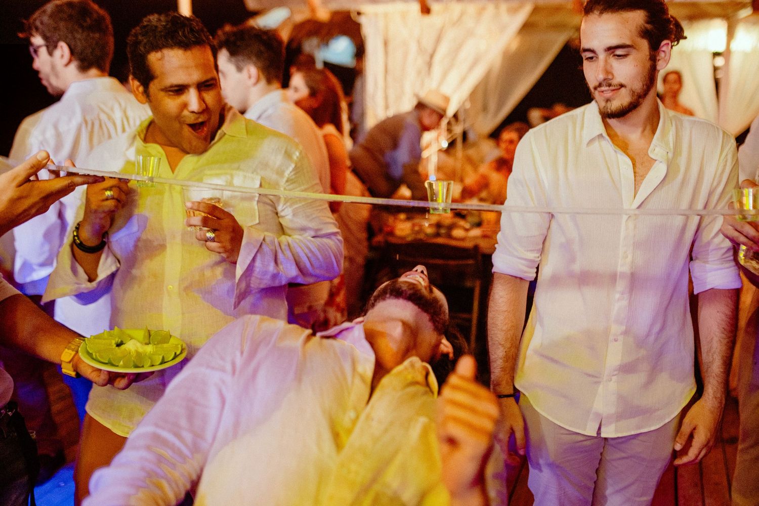 Colorful dance floor moments captured during an energetic wedding reception celebration.