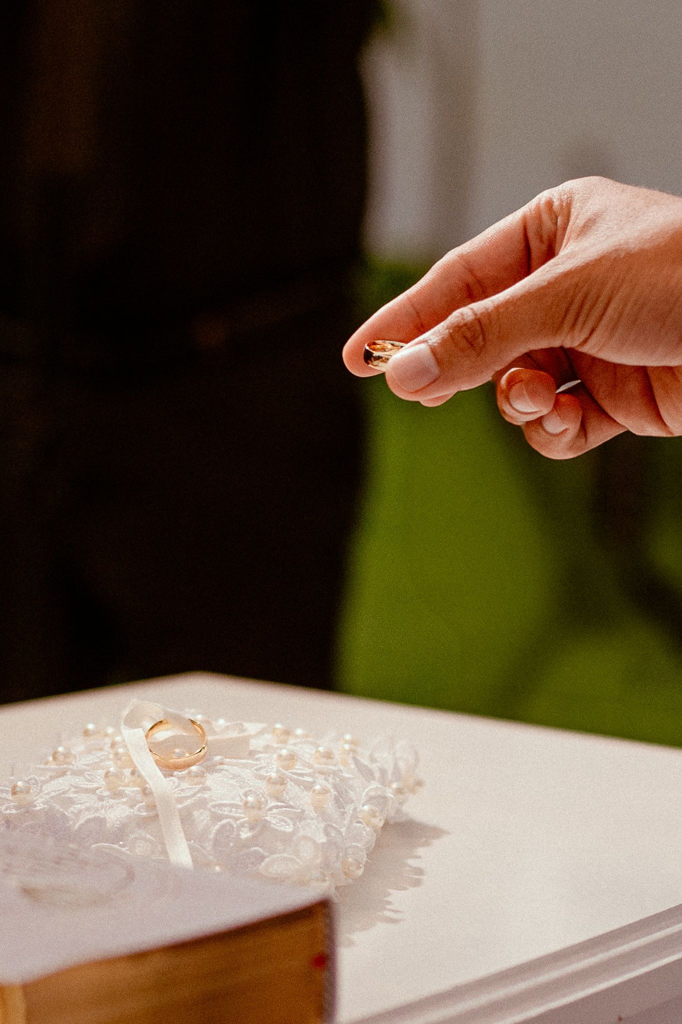 A finger drops a small clear bubble wrap bubble onto a white surface in a sequence of motion shots.