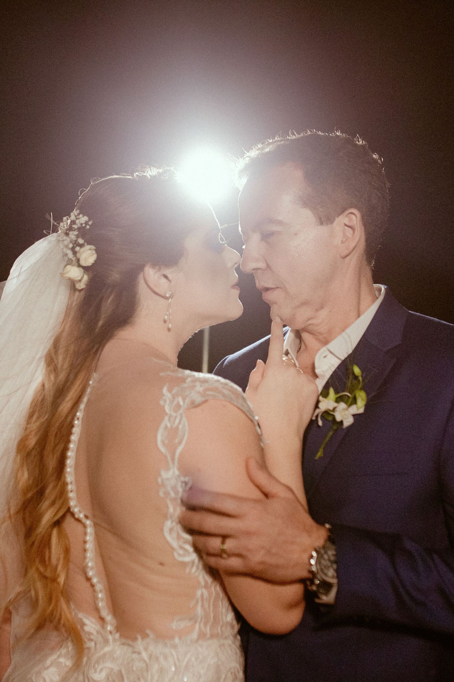 A romantic sequence of candid moments between a bride and groom dancing during their wedding reception.