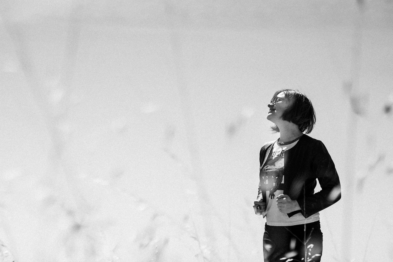 Black and white artistic portrait against a minimalist background.