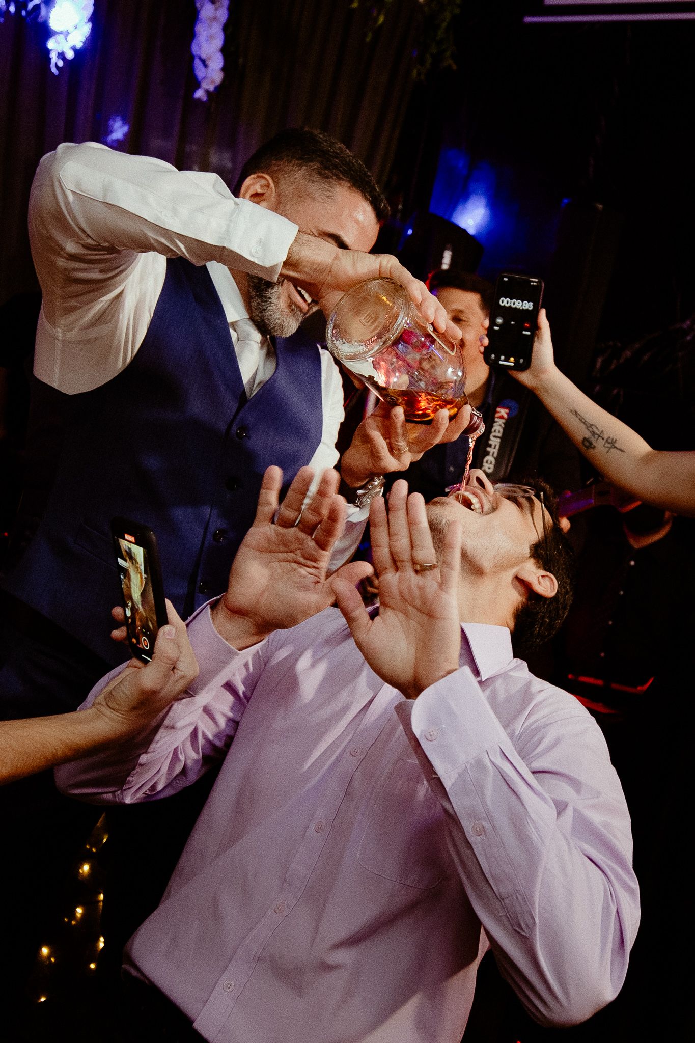 A sequence of party shots showing someone taking multiple shots of alcohol at a nighttime celebration event.