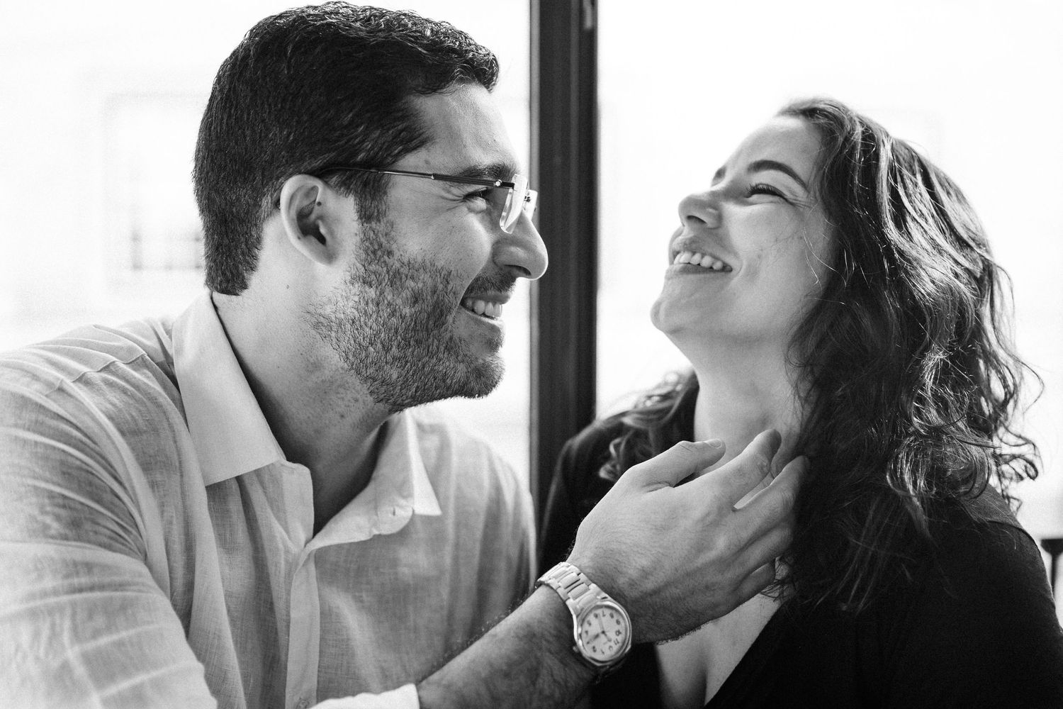 A collection of black and white profile portraits showing intimate expressions and laughter between couples.