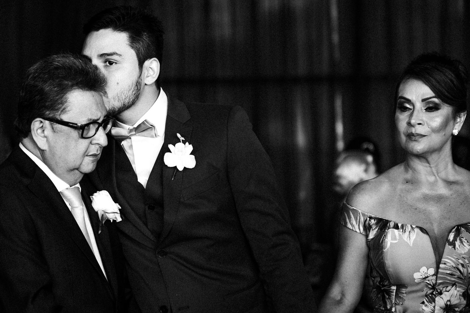 A collection of black and white wedding photos arranged in a horizontal grid shows intimate moments between couples.