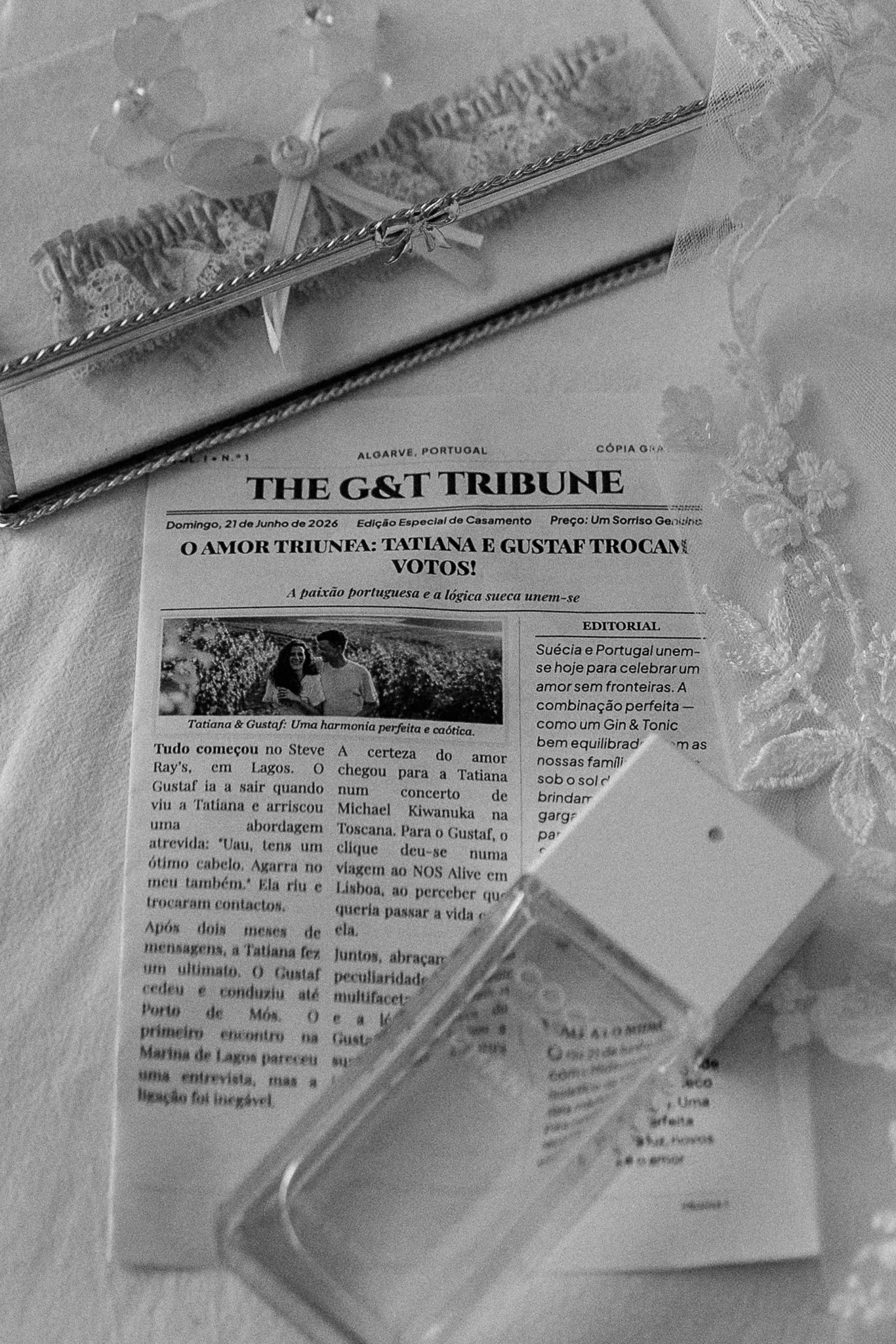 Black and white photo of The G&T Tribune wedding newspaper on a decorated table in Algarve, Portugal.