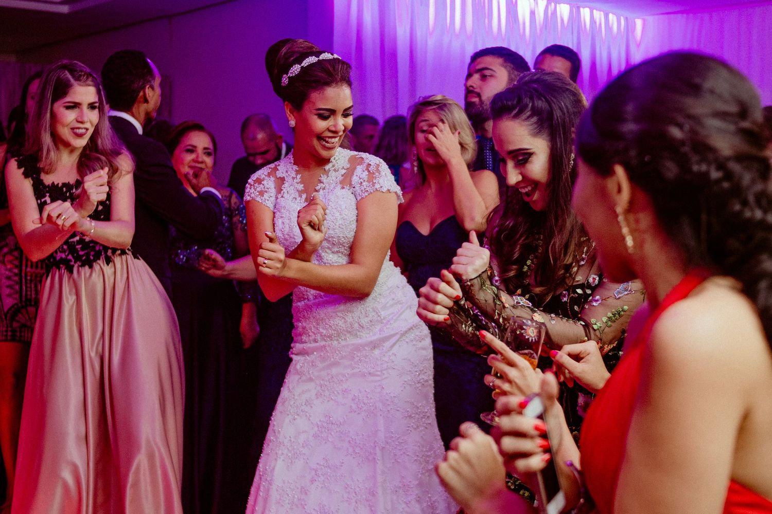 Wedding reception dance floor with purple lighting and festive atmosphere.
