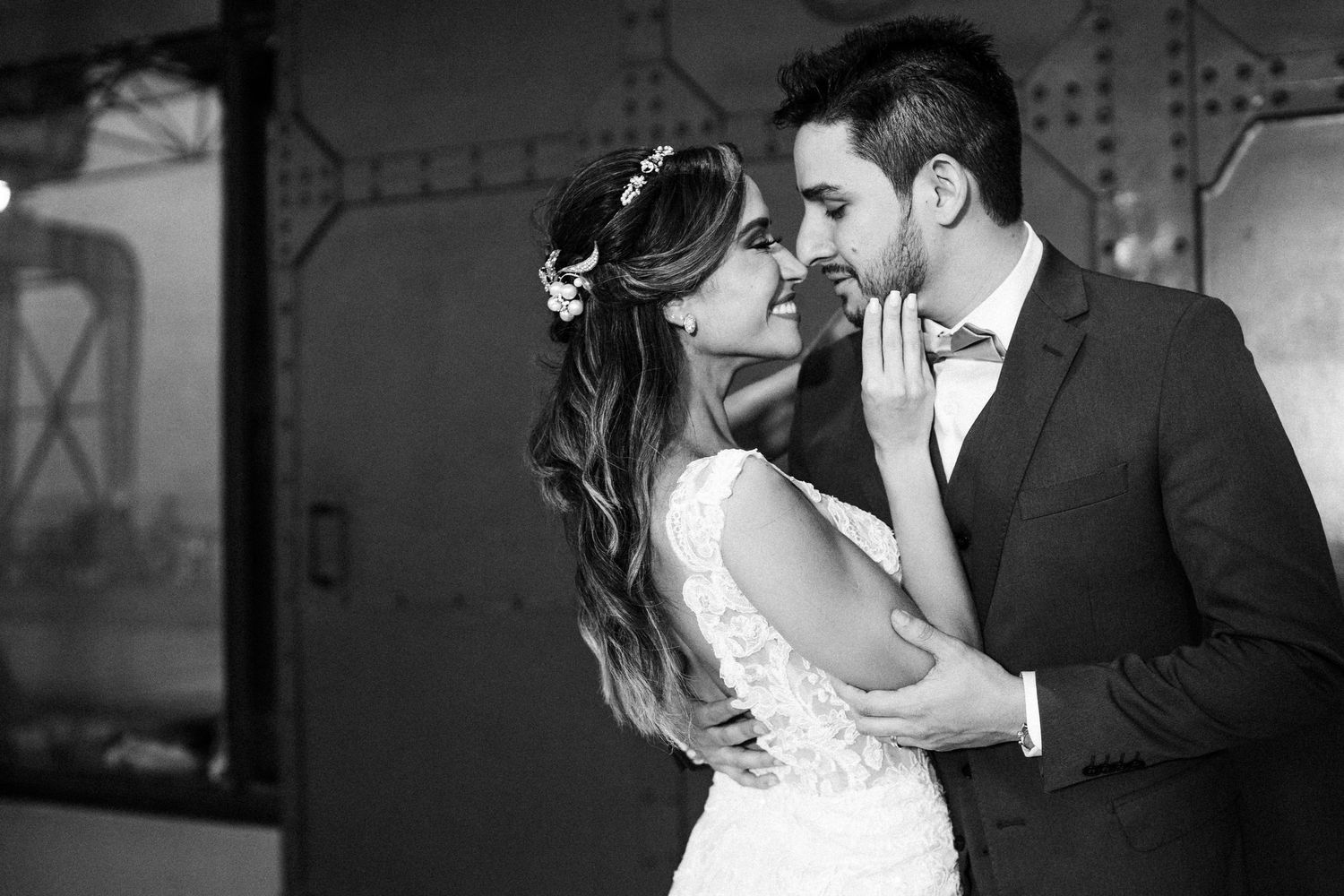 Romantic bride and groom share tender moments in black and white wedding photography series.