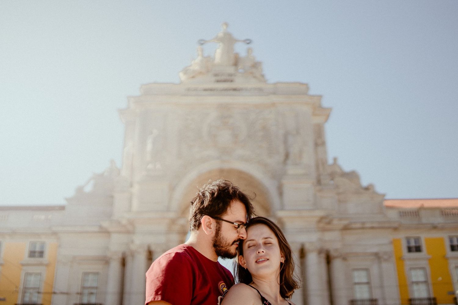 A romantic engagement photoshoot takes place in front of a grand white colonial church in Mexico.