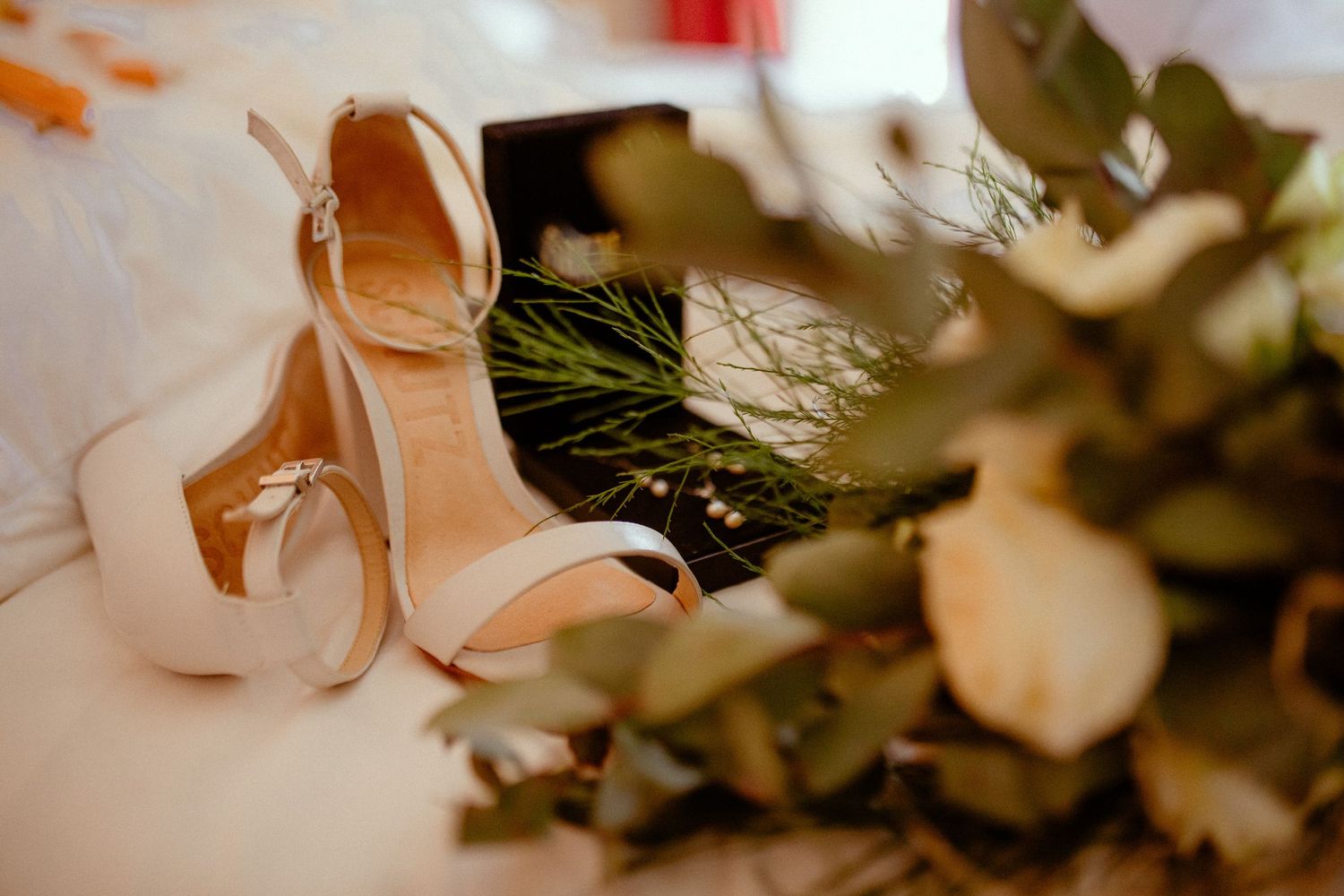 A series of abstract wedding photography images with bokeh effect showing rings and romantic details in warm tones.